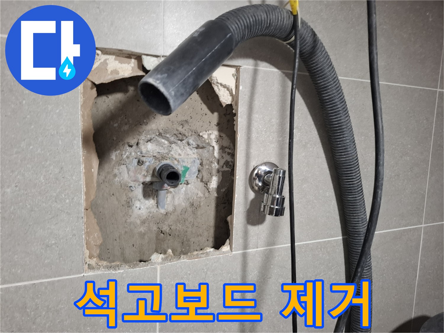 욕실 배관 주변 석고보드 잔해 제거 작업 중