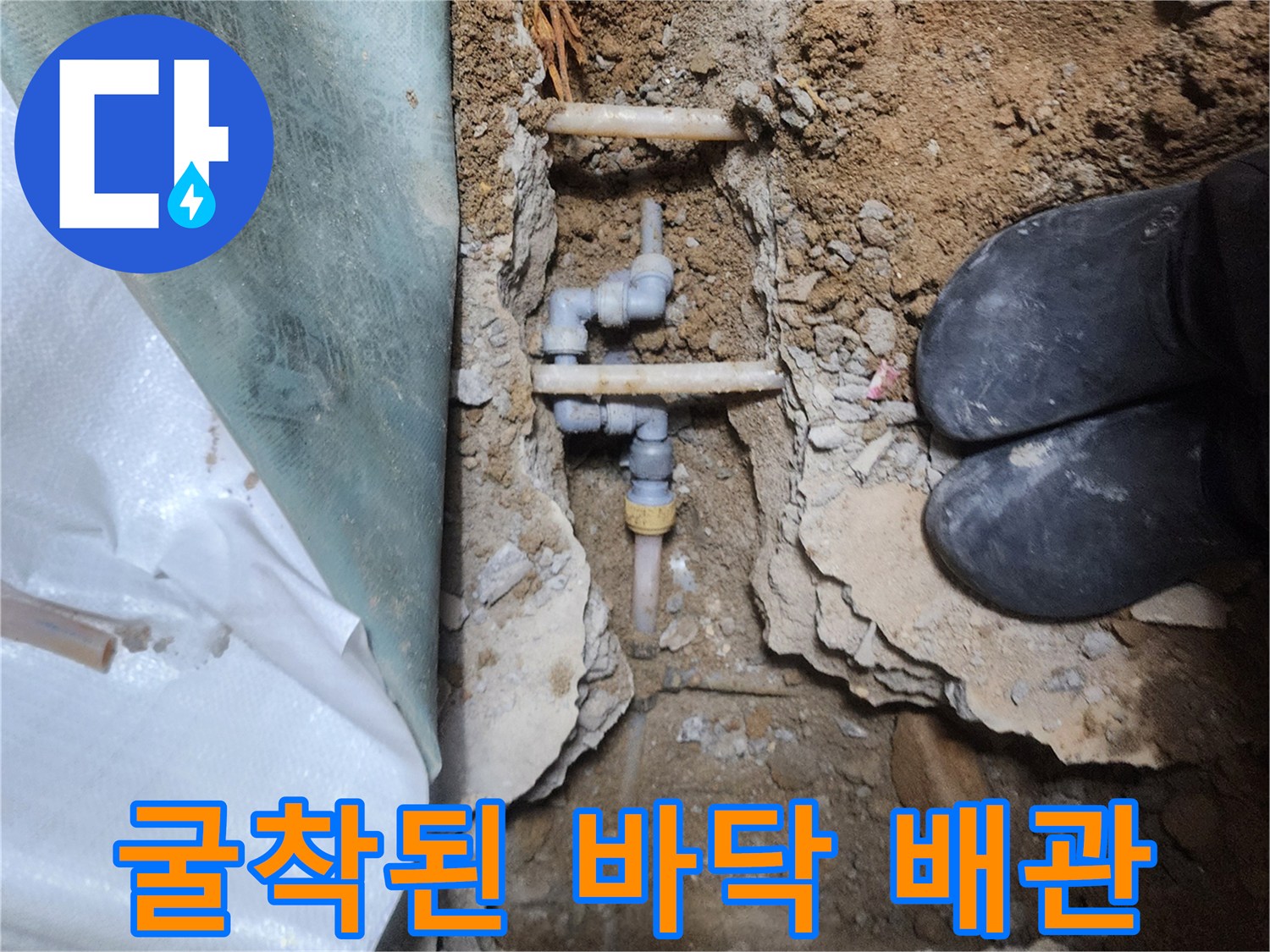 흙과 콘크리트 사이로 드러난 수도 배관 연결 부위