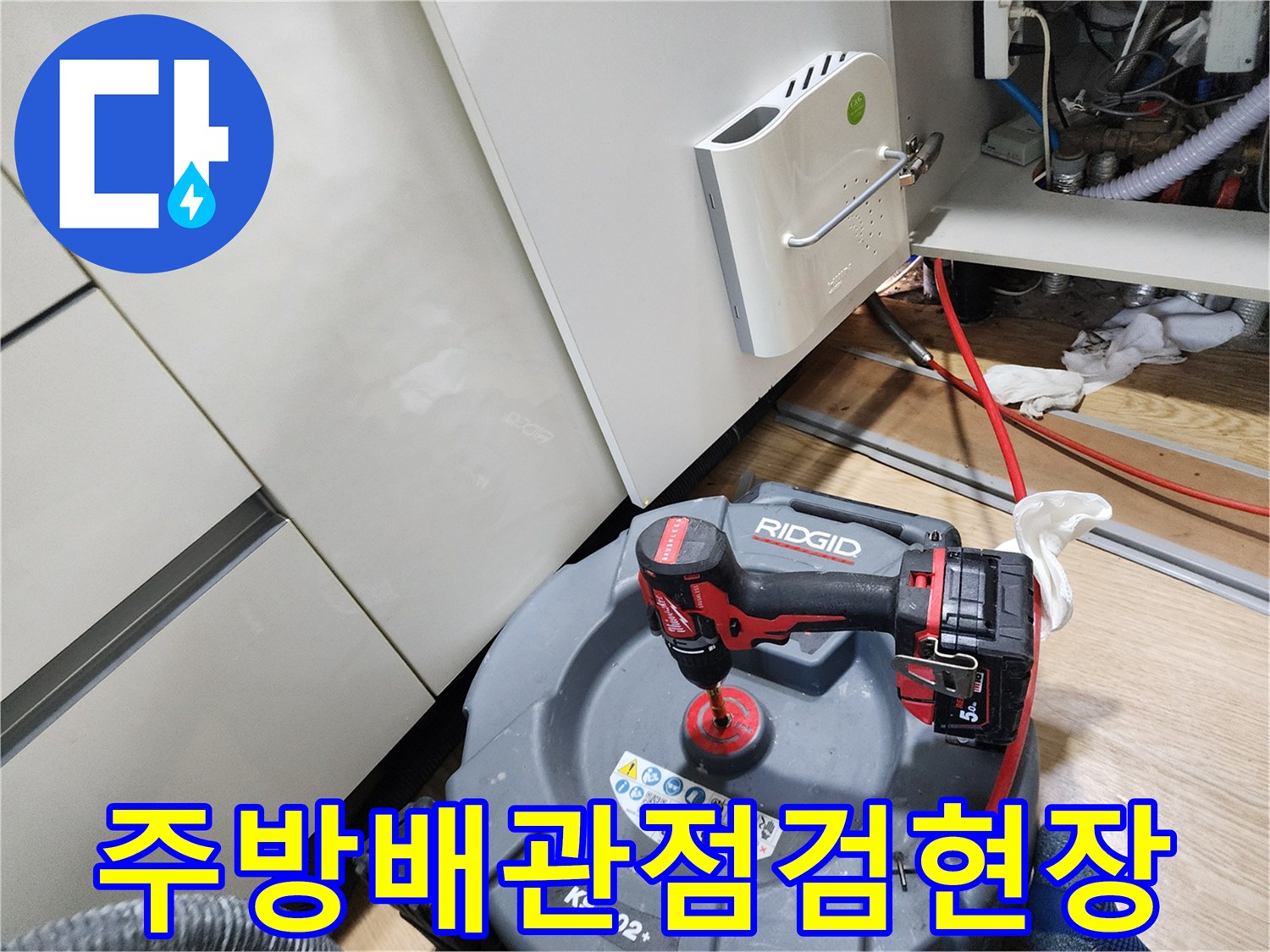 주방 싱크대 아래쪽에서 진행 중인 배관 점검 작업 모습입니다.
