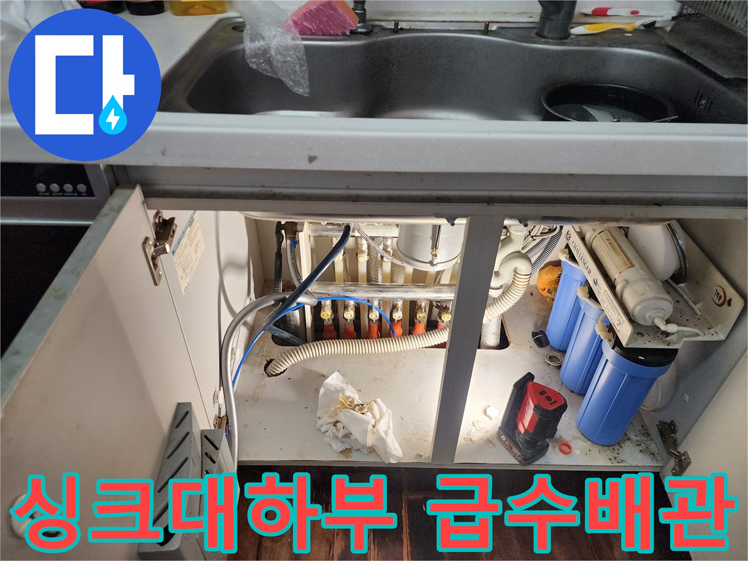 싱크대 아래-정수기 필터와 연결된 복잡한 배관들