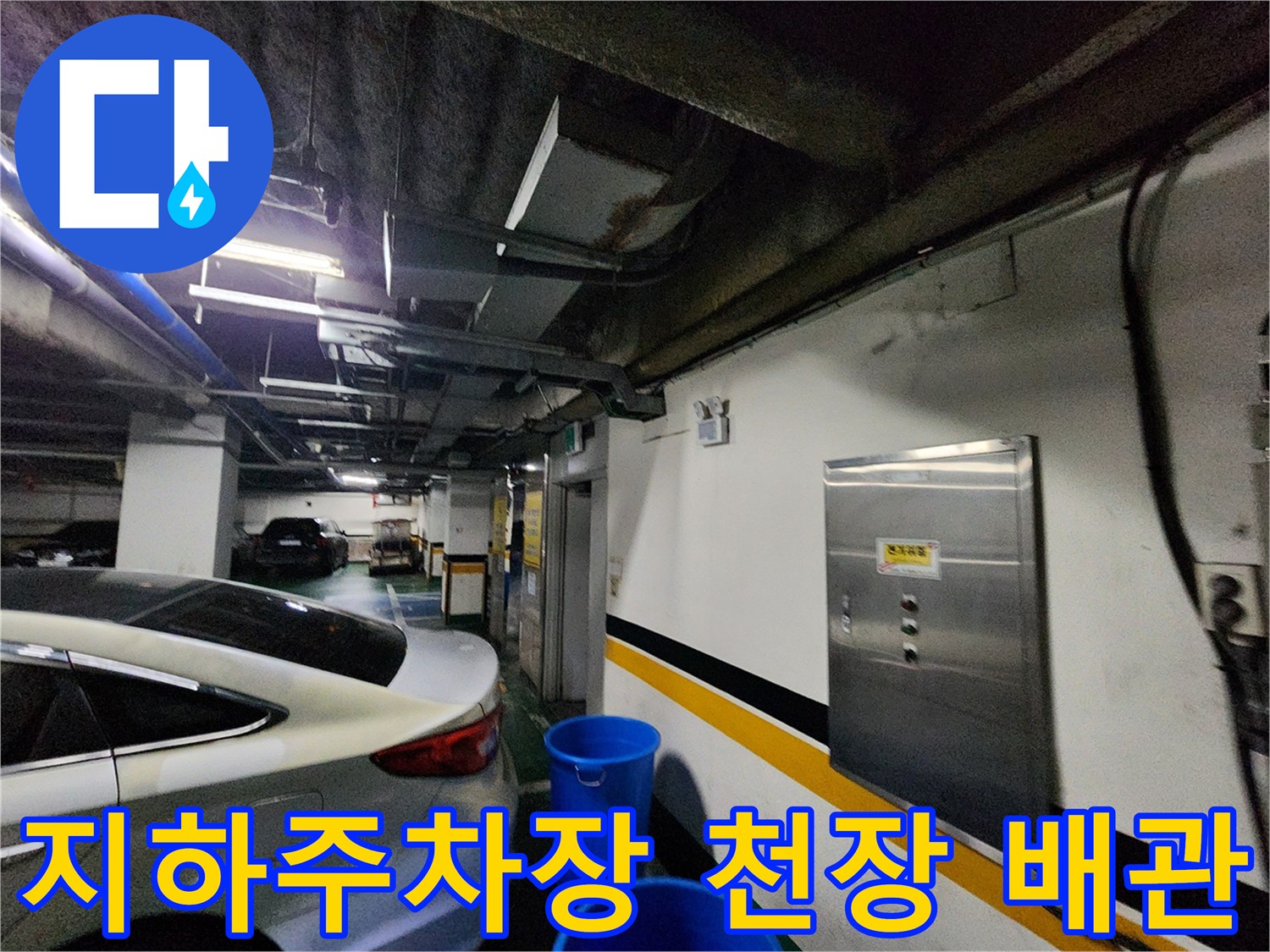 지하 주차장 천장 부근의 노출된 배관과 습기 상태를 보여주는 사진입니다.