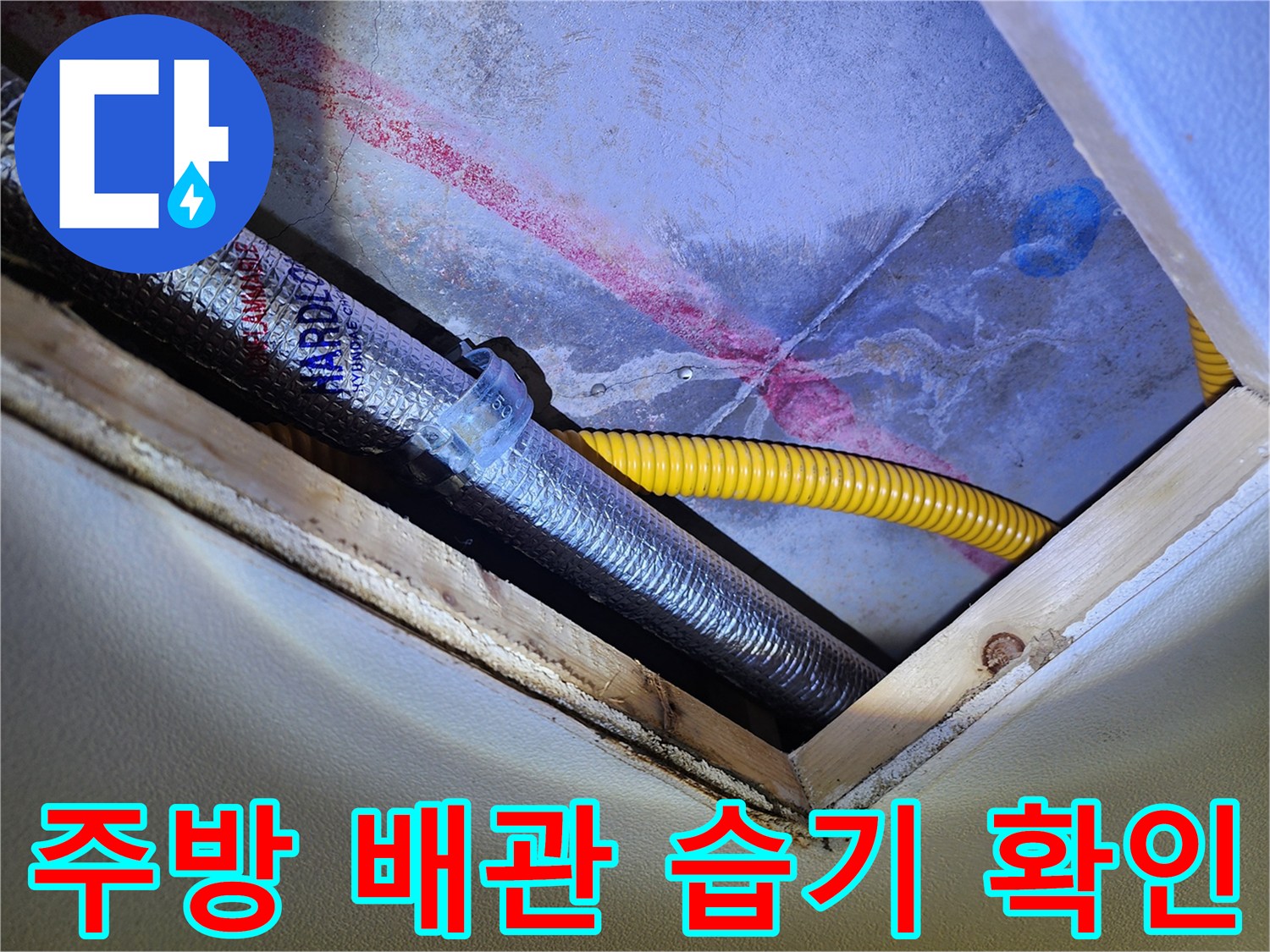 주방 싱크대 하부 - 은색 보온재 배관과 노란색 호스 주변의 습기 상태