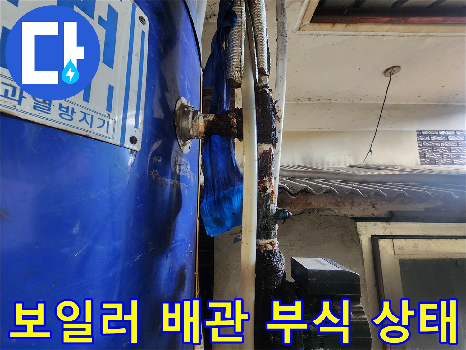 파란색 보일러 본체와 연결된 배관 부위에 심한 녹과 물때가 발생한 모습