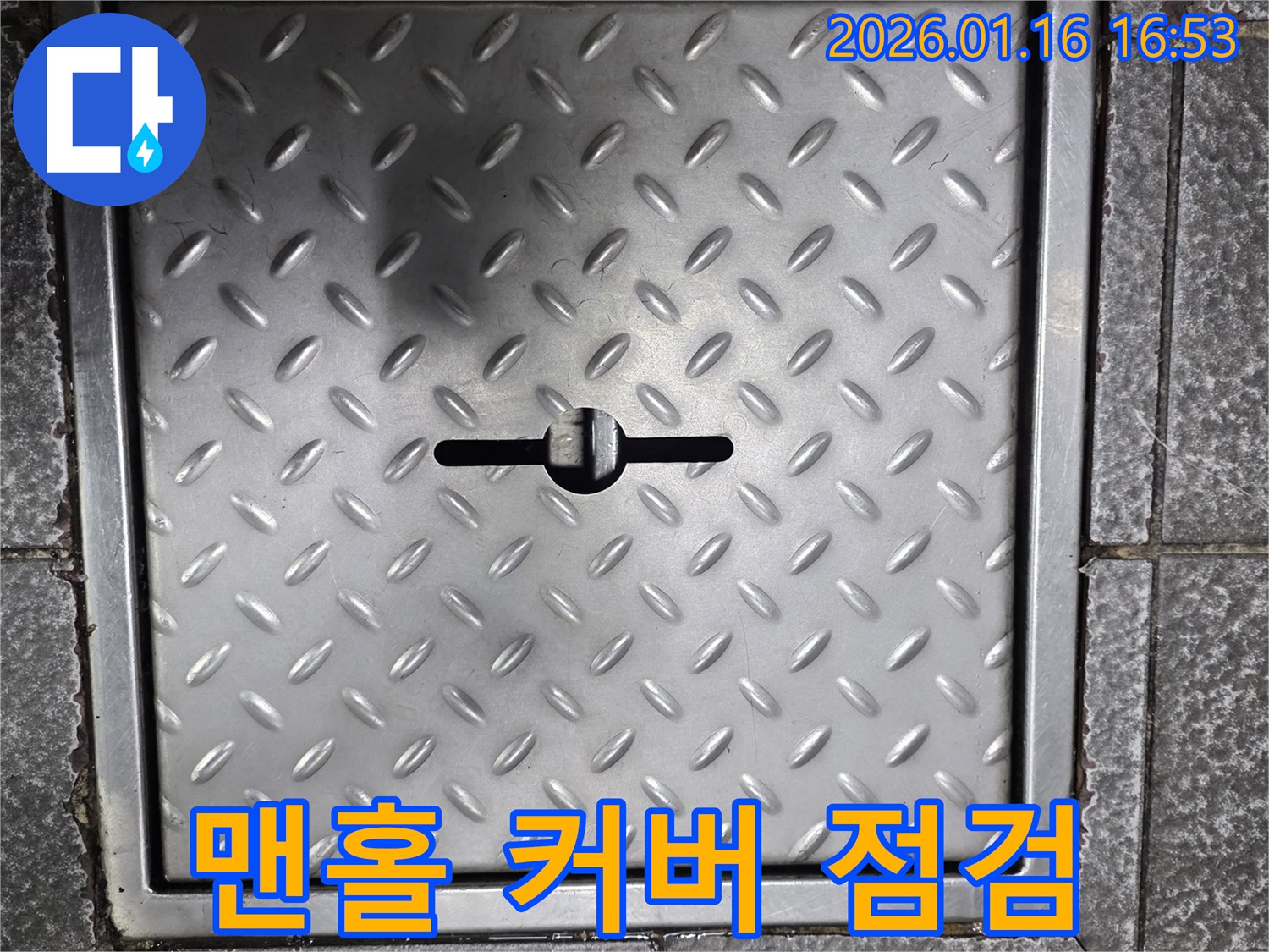 외부 배관 시스템에 접근하기 위해 맨홀 커버를 점검하는 모습 - 누수 공사의 첫 단계입니다.