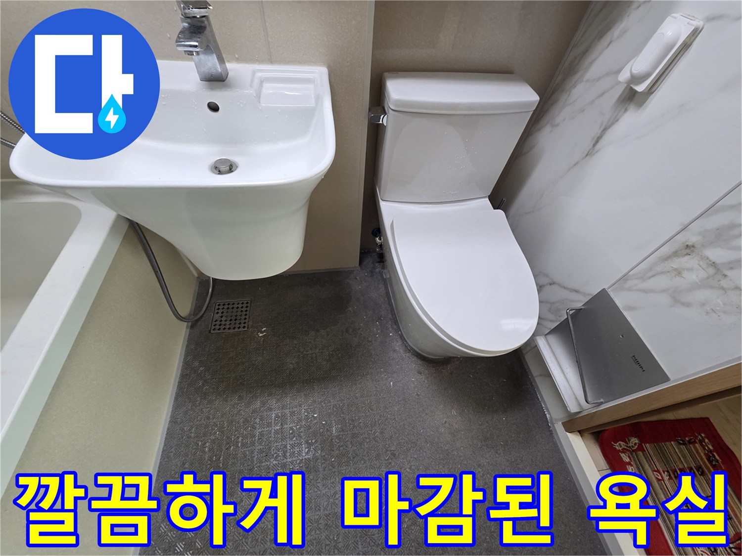 세면대와 변기가 설치된 깨끗한 상태의 욕실 내부 모습입니다.