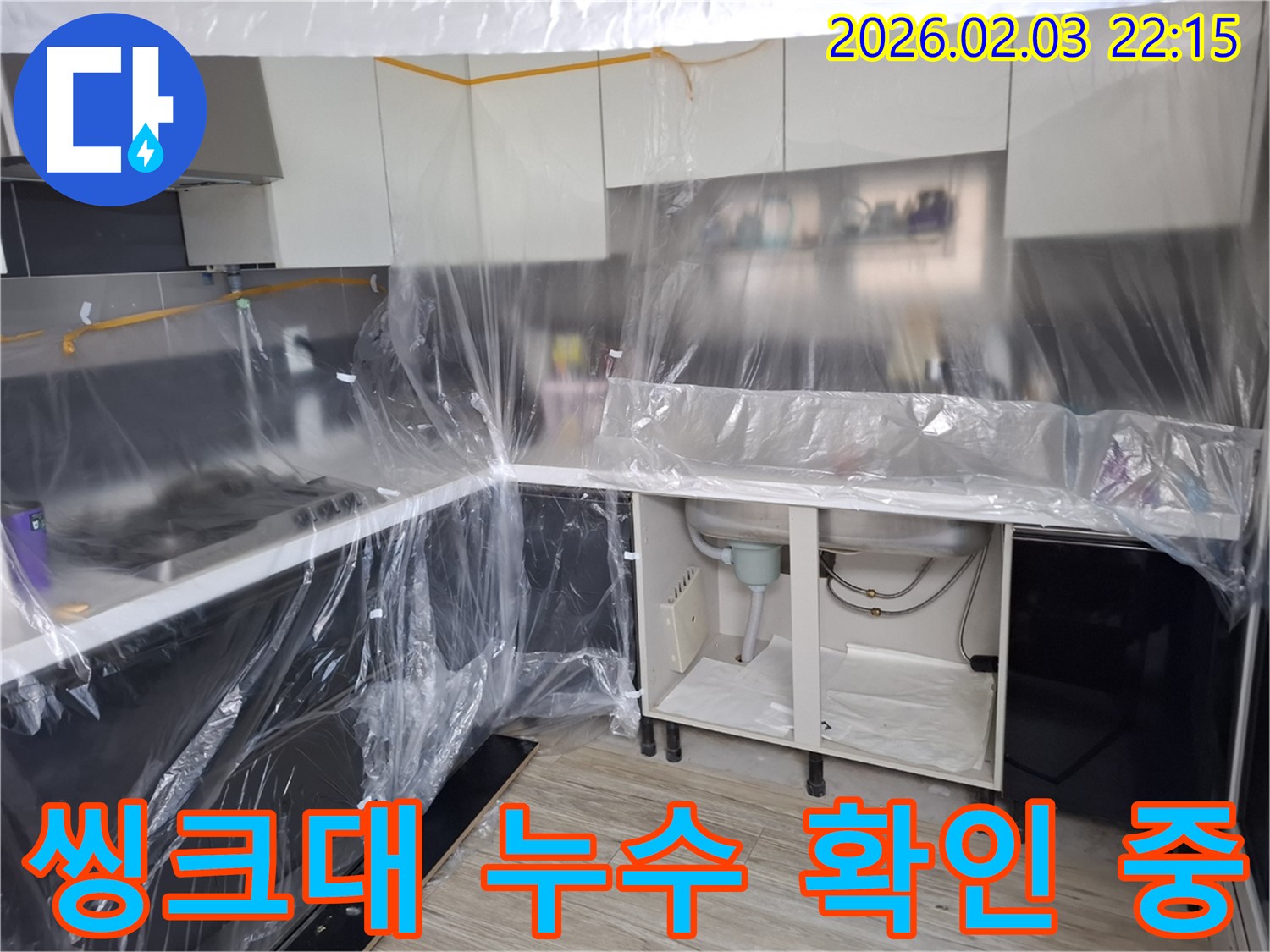 씽크대 누수 확인 중 - 누수 지점을 찾기 위해 꼼꼼하게 살펴보고 있습니다. 숙련된 기술로 문제 해결!