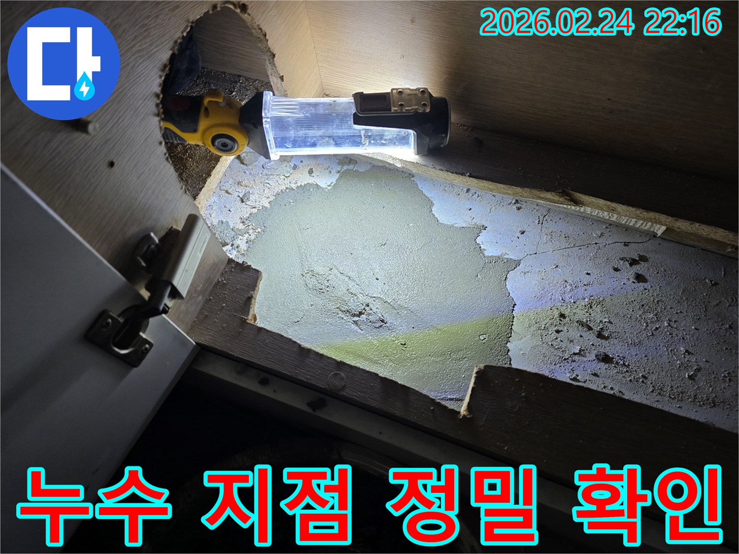 어두운-캐비닛-아래에서-누수-흔적을-발견하고-정밀하게-조사하는-누수-전문가의-작업-모습