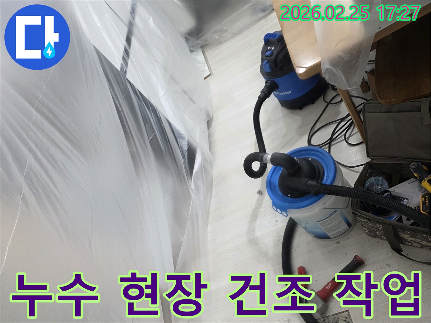 누수 발생으로 개방된 바닥과-습기 제거를 위한-전문 장비가 설치된-작업 현장입니다