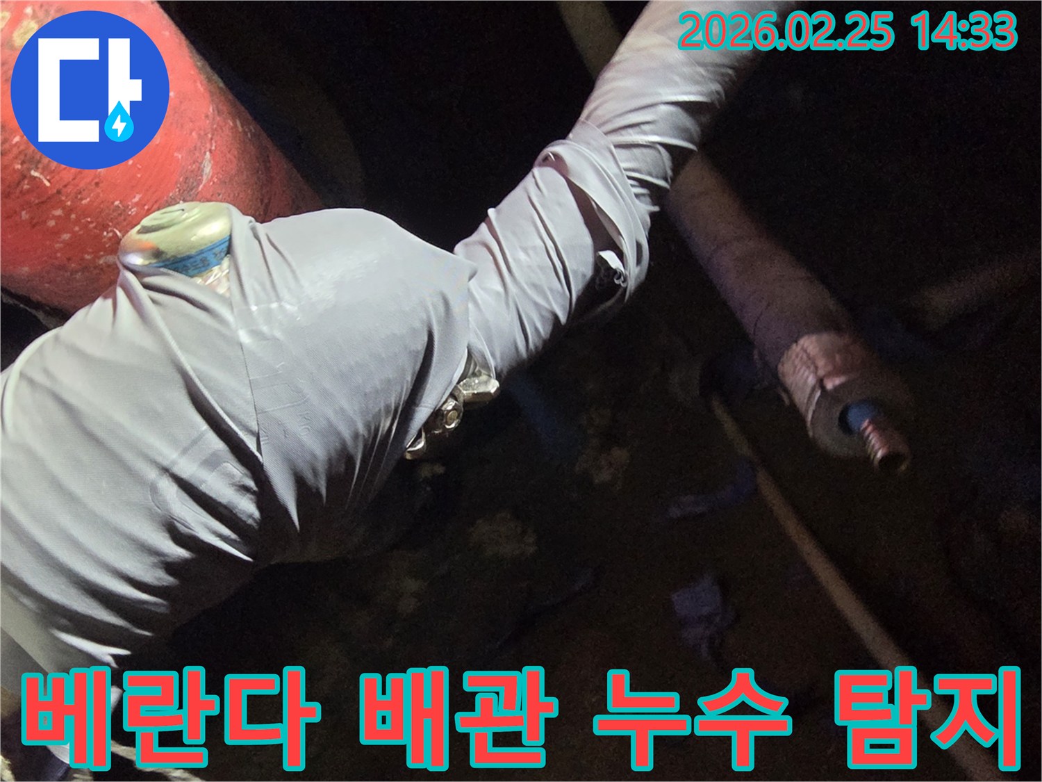 누수-전문가가-빌라-베란다-누수-원인을-찾기 위해-배관에-탐지-장비를-연결하는-사진