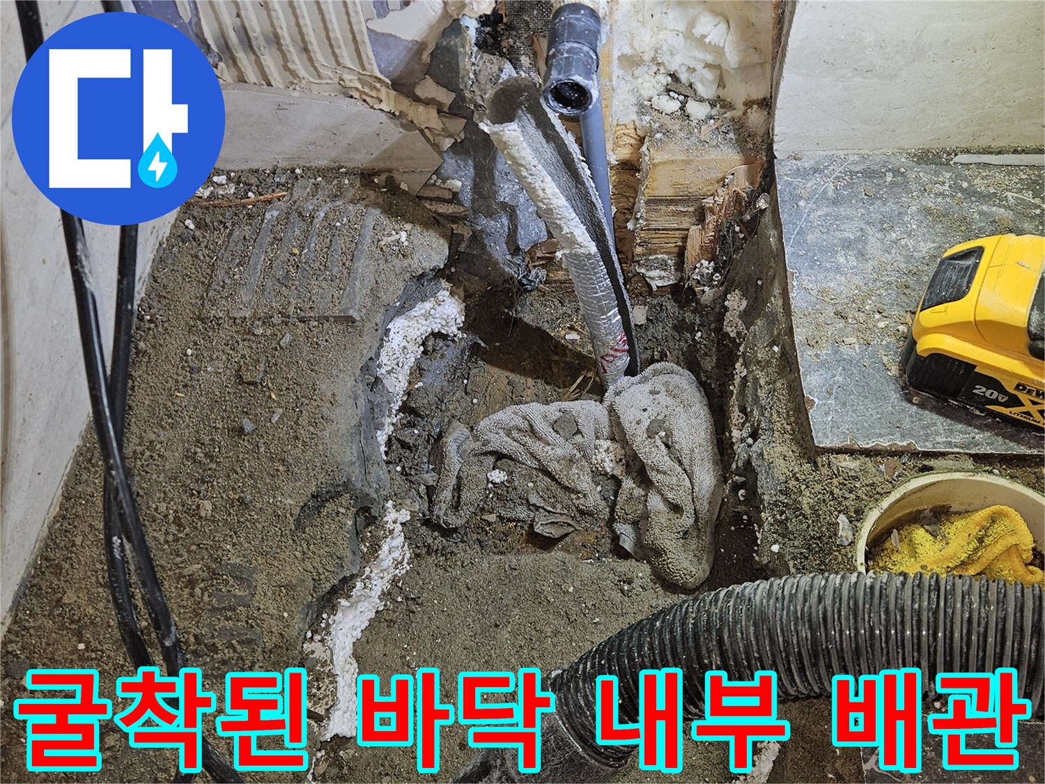 욕실 타일 아래 드러난 젖은 흙과 손상된 수도 배관