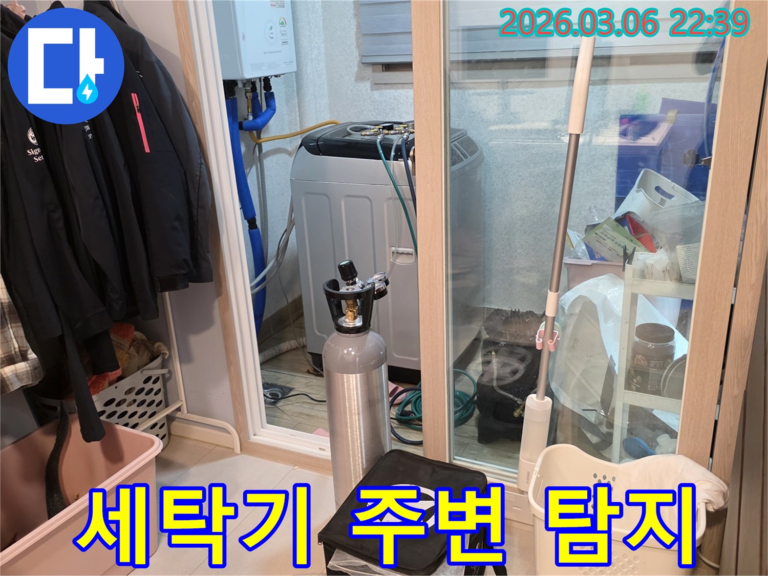 세탁실 세탁기 주변의-배관 누수 여부를-정밀하게 확인하기 위해-가스 탐지 장비를-설치하고 있습니다