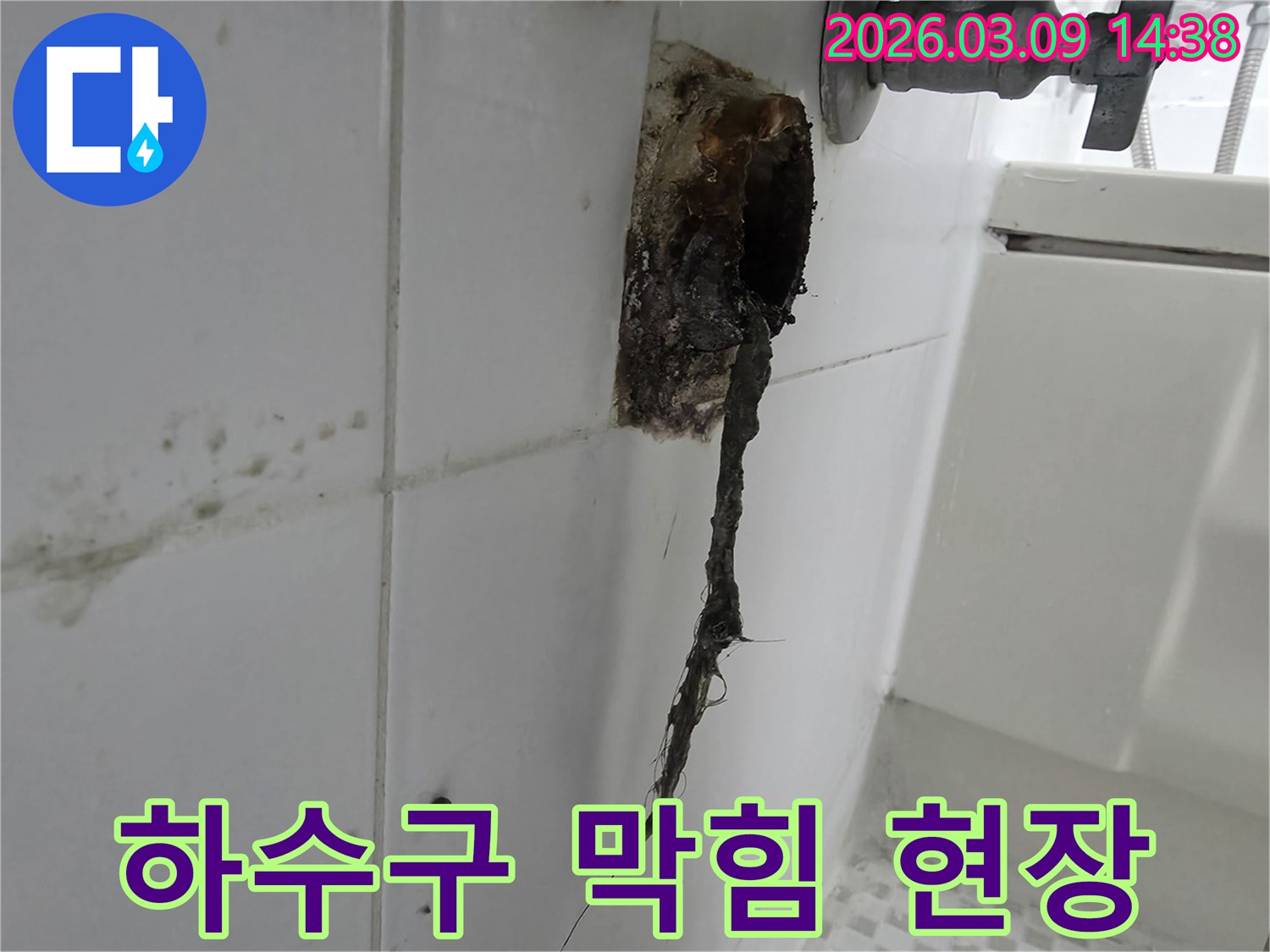 배수구 구멍에서-검은색-이물질이-길게-늘어져-나온-문제의-현장-사진입니다.
