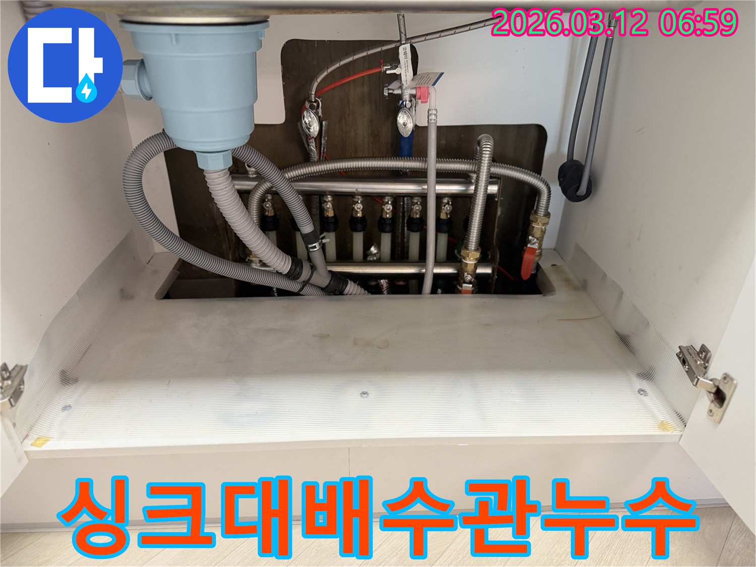 마포구-아파트-싱크대-하부의-복잡한-배수관에서-발생한-누수-현장을-정밀하게-촬영한-사진입니다.