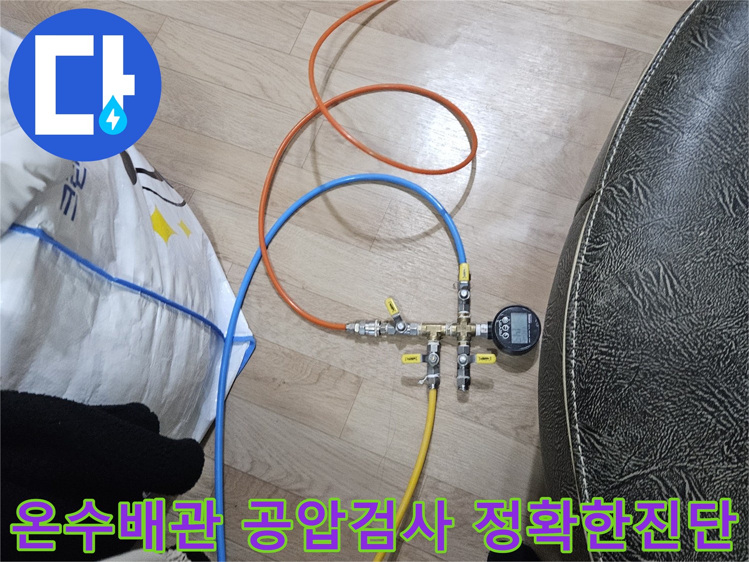 누수 엔지니어가 온수 배관의 누수 여부를 정확하게 확인하기 위해-공압 검사 장비를 연결하여 압력을 측정하고 있습니다