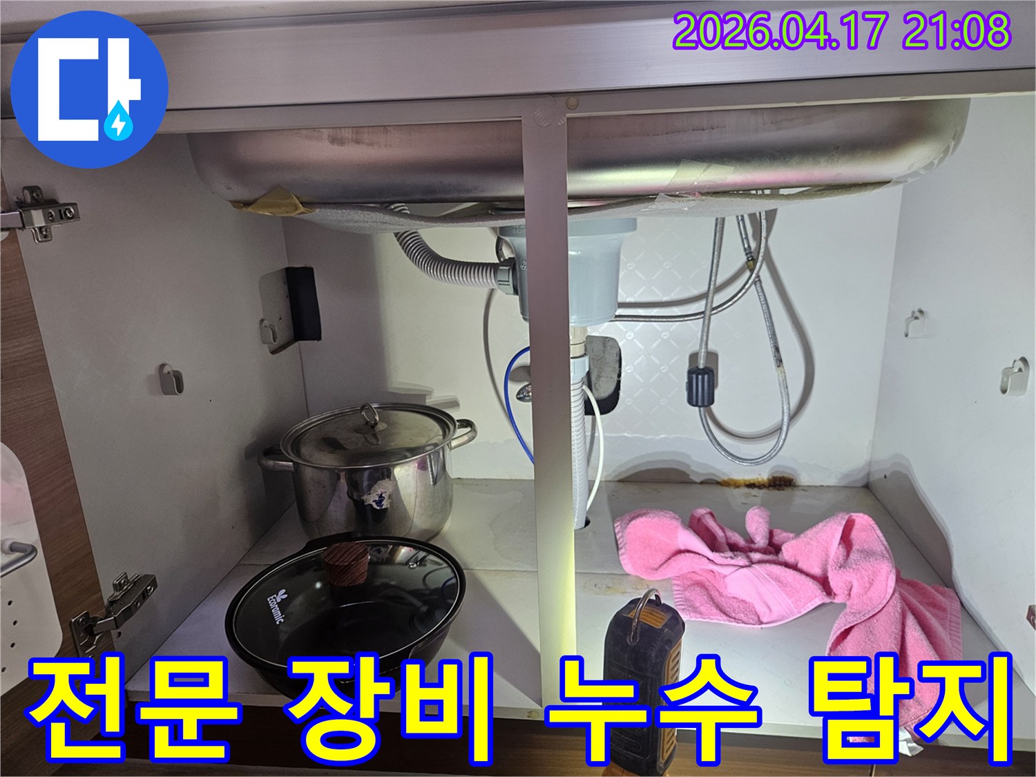 싱크대-하부-누수-현장에서-전문-장비를-사용하여-누수-지점을-정확하게-탐지하는-모습을-담은-사진입니다