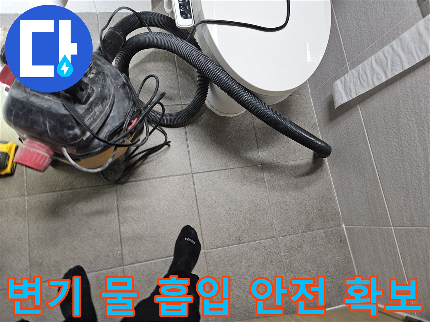 오산시 아파트 화장실에서-누수 엔지니어가-변기 주변에 고인 물을-습식 청소기로 흡입하며-고객의 안전을 확보하는 모습