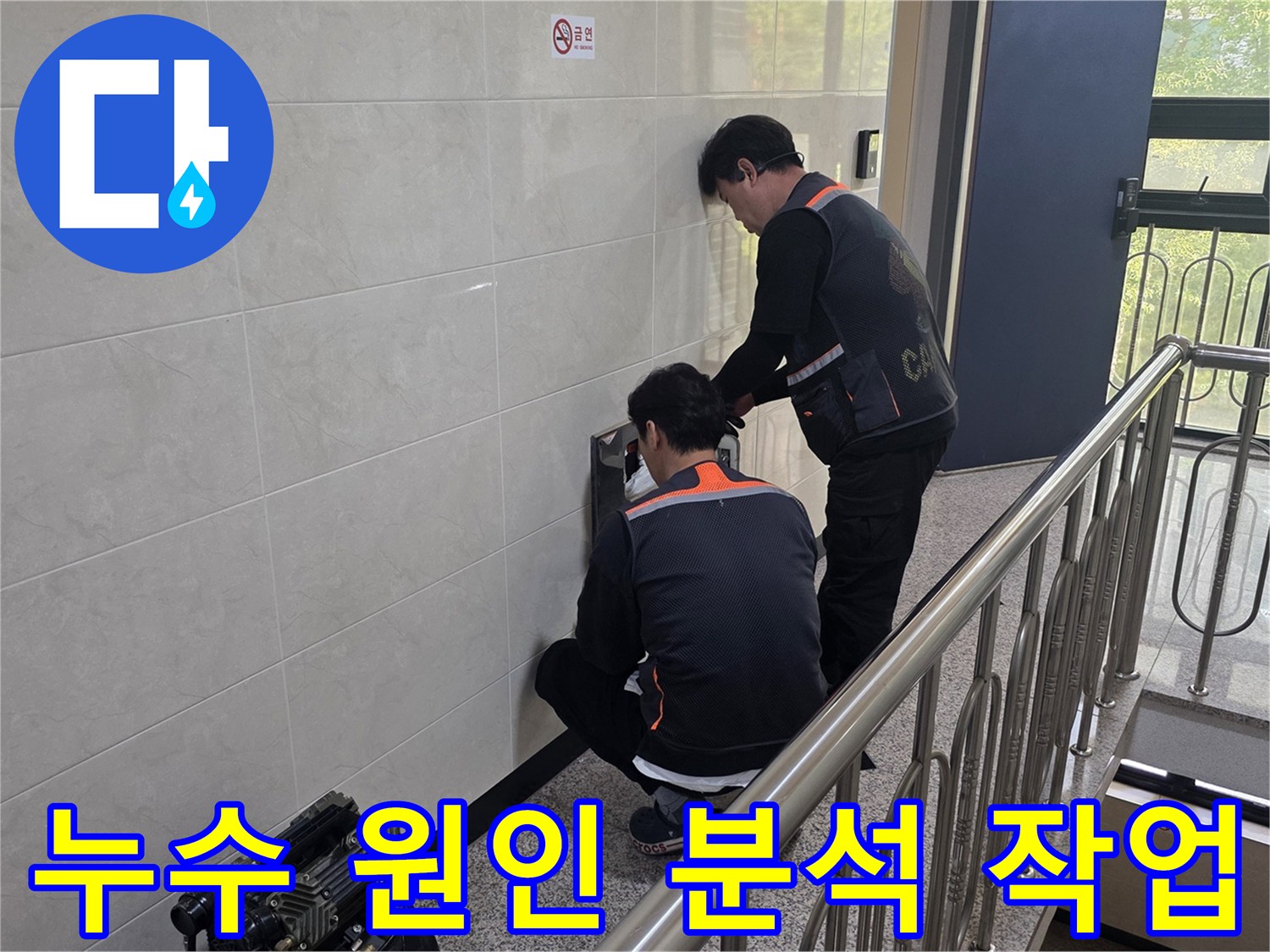 두 명의 전문 기술자가 건물 벽면의 누수 의심 지점을 정밀하게 분석하며 근본적인 원인을 파악하고 있습니다-재발 방지를 위한 중요한 단계입니다.