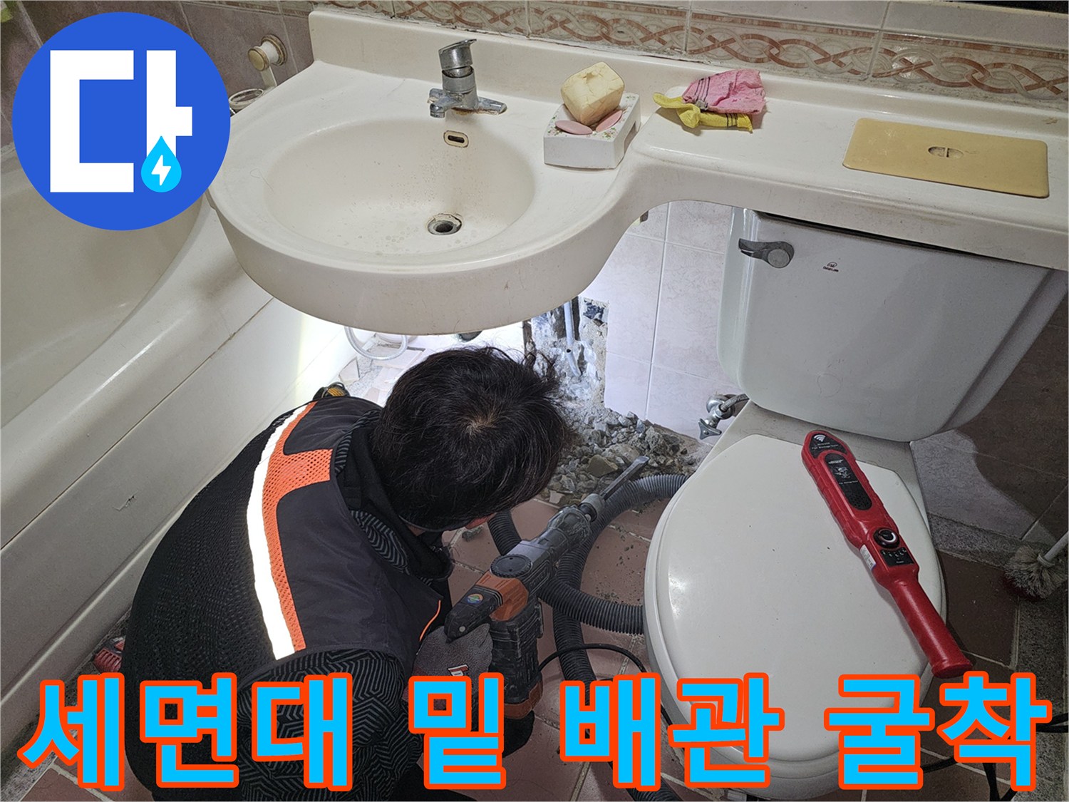 세면대 아래 벽을 파내어 누수된 배관 연결부를 노출시킨 사진