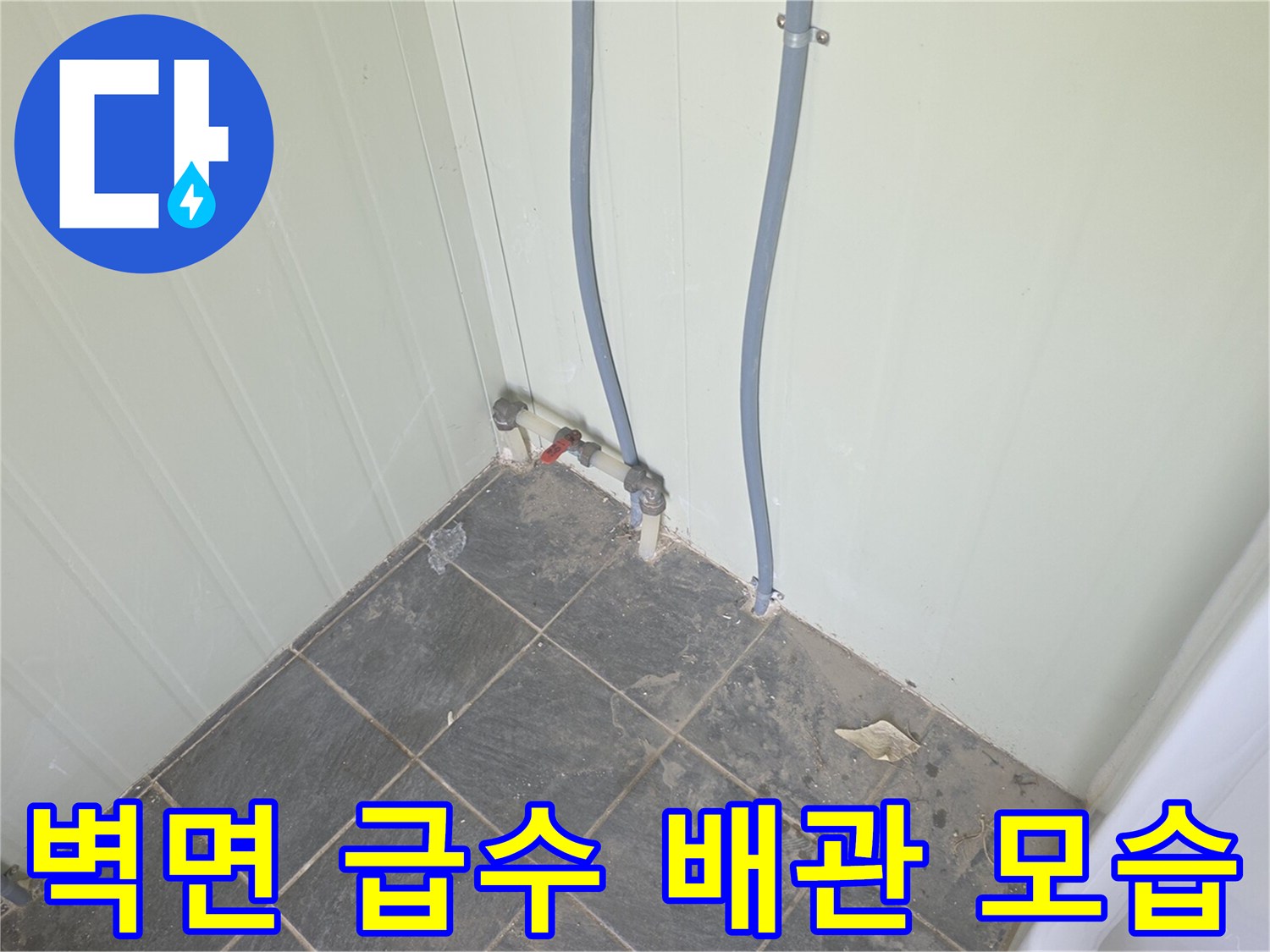 화장실 벽면에 설치된 소변기용 급수 배관과 연결 부속