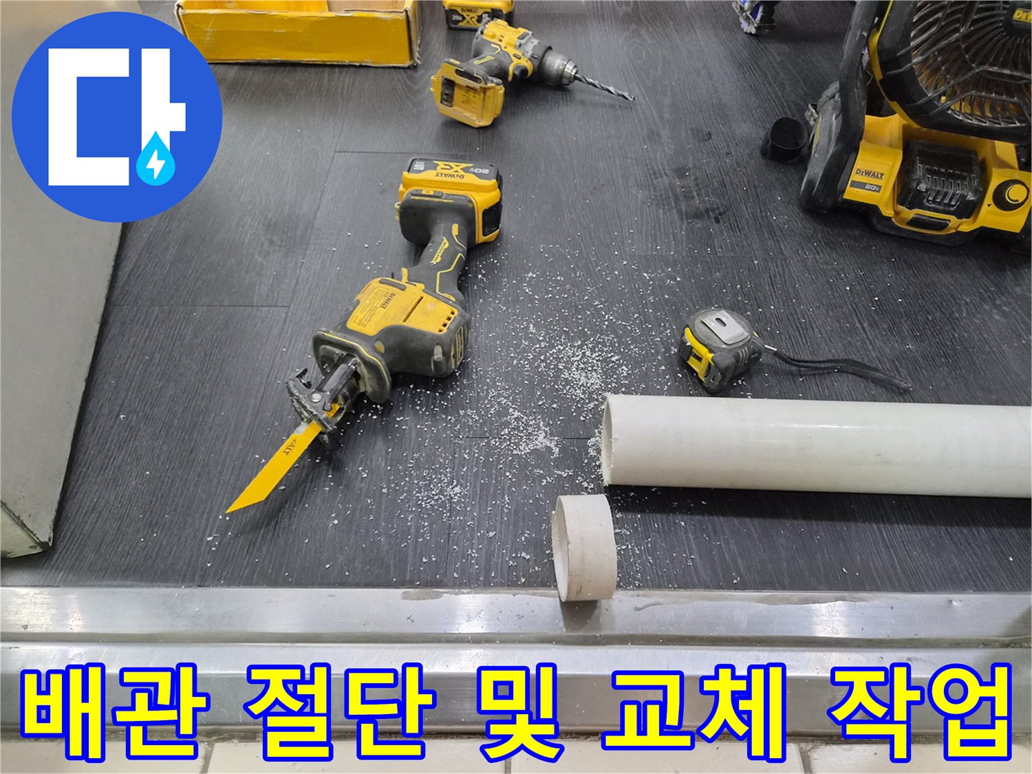 소변기 배관 수리를 위해 절단된 PVC 파이프와 전동 공구