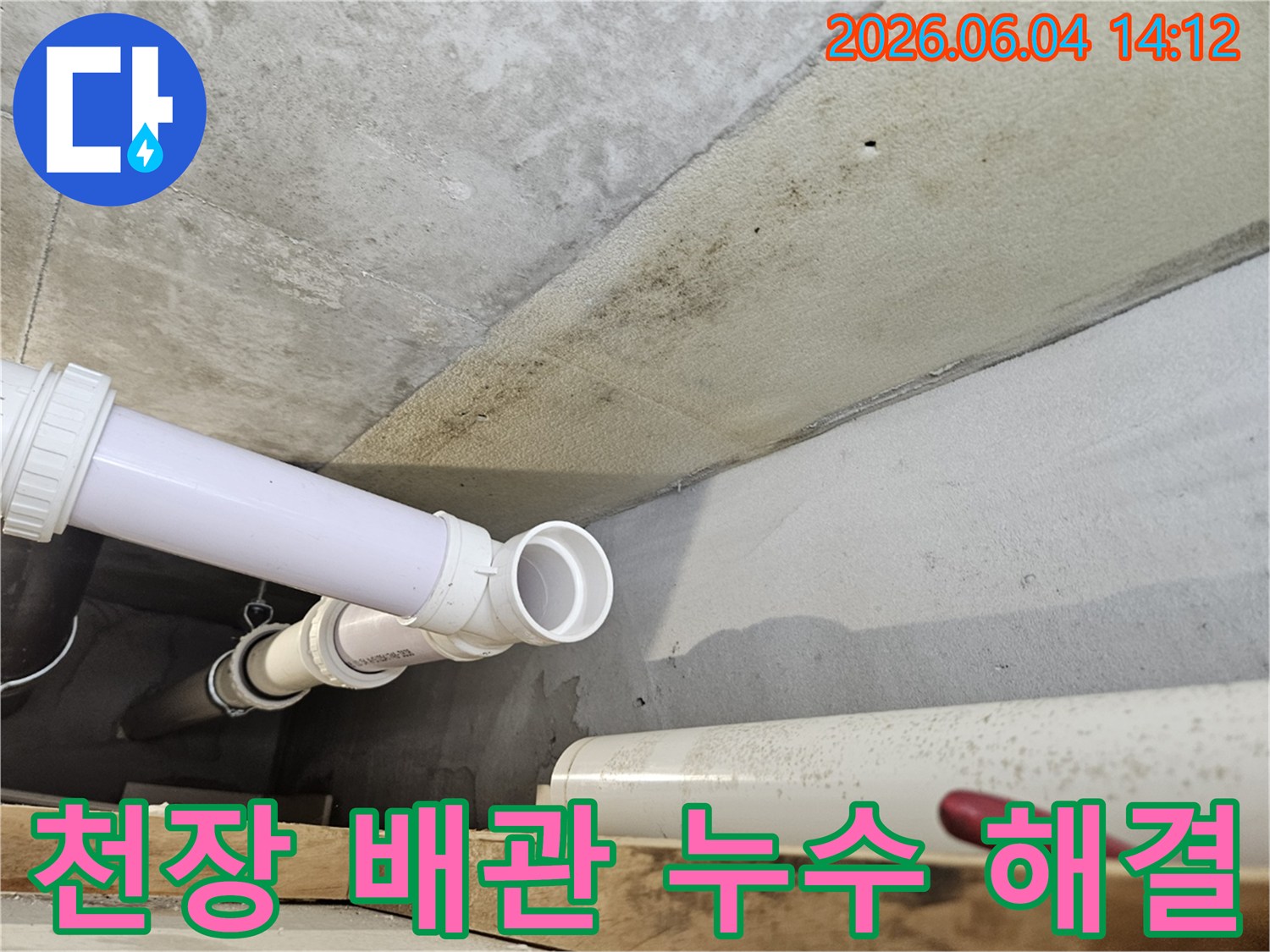 콘크리트 천장 아래에 설치된 PVC 배관 주변에-누수로 인한 광범위한 곰팡이와-오염이 발생한 현장 이미지