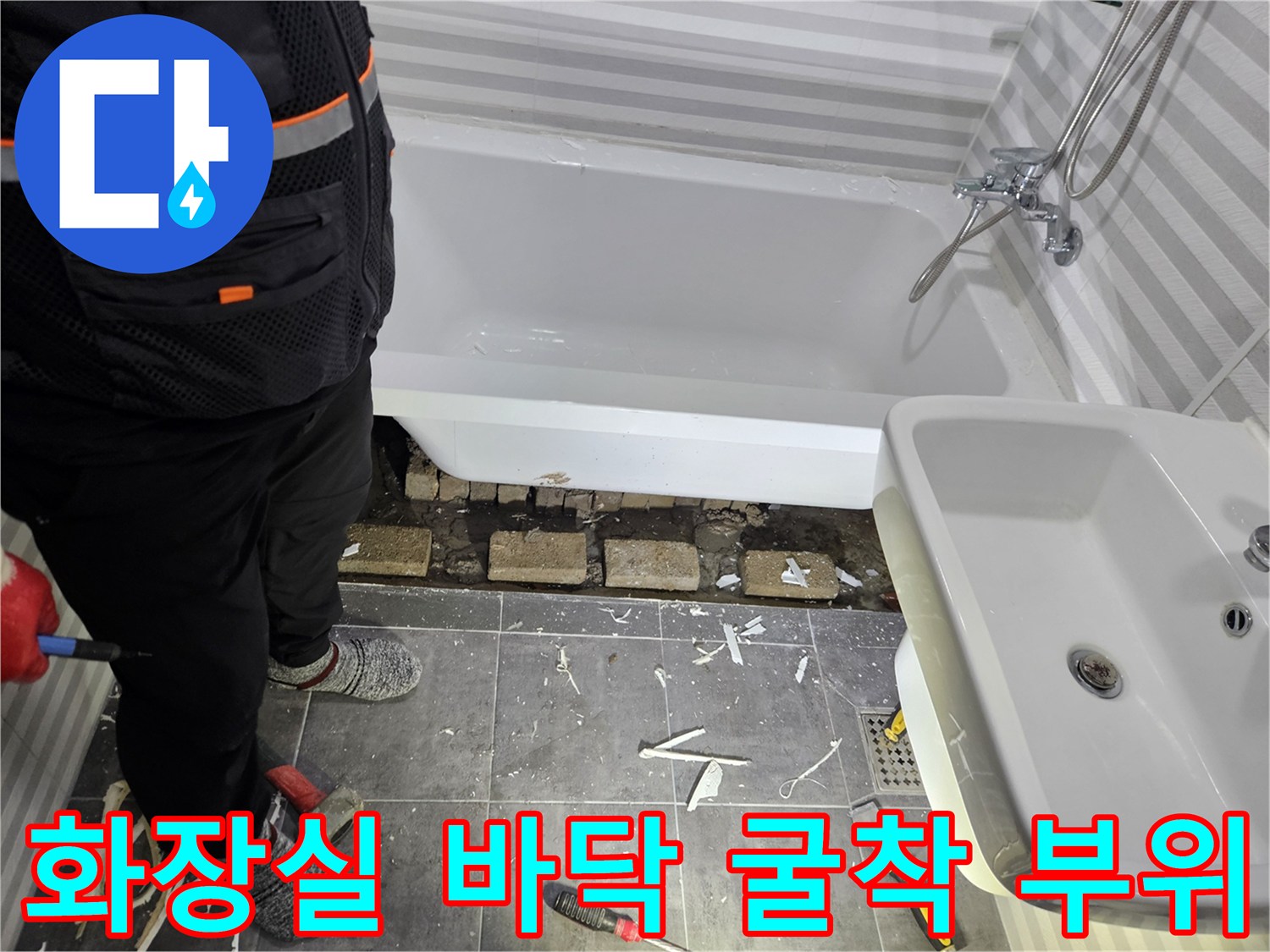 욕조 탈거 후 노출된 배관과 파손된 타일 조각들