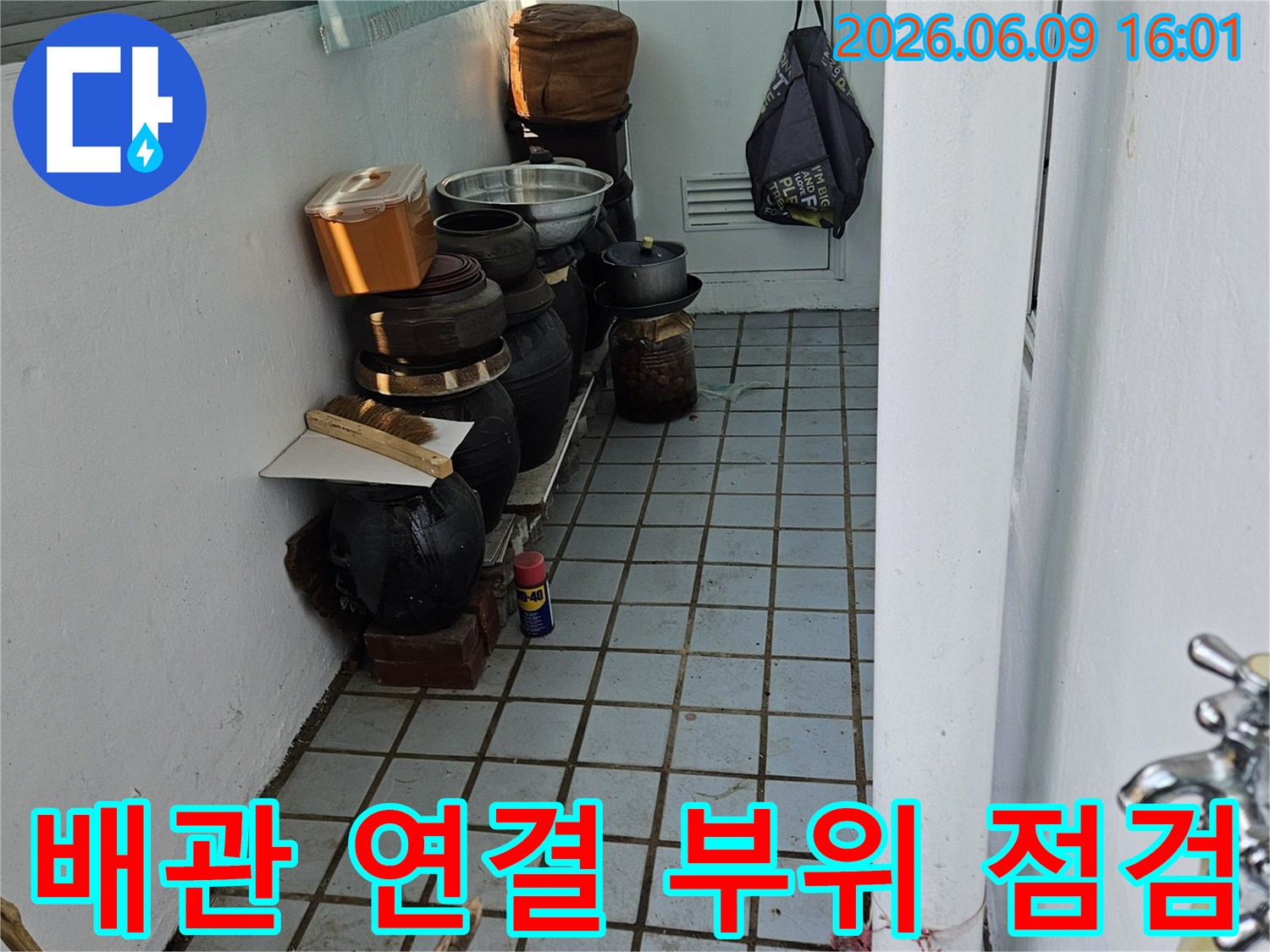 의정부 한신아파트 베란다에서-배관 연결 부위의 누수 여부를-집중적으로 점검하는 모습