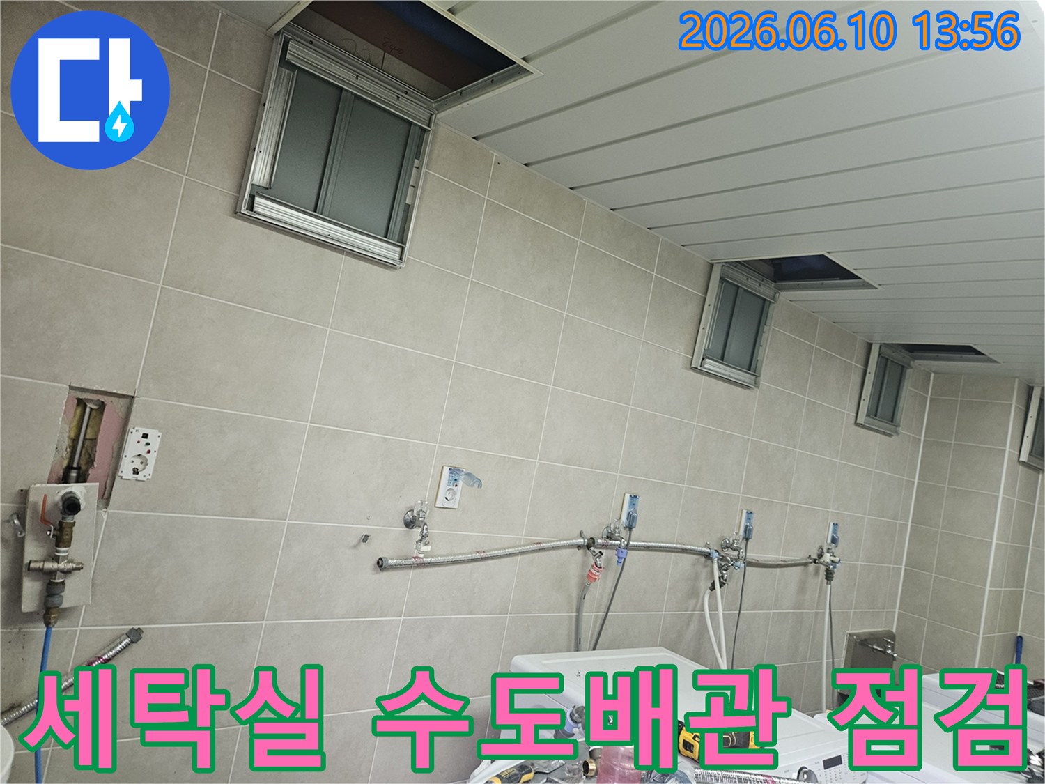 세탁기 옆 벽면에 설치된 수도배관과-밸브 연결 부위를 꼼꼼히 점검하는-누수 엔지니어의 시선
