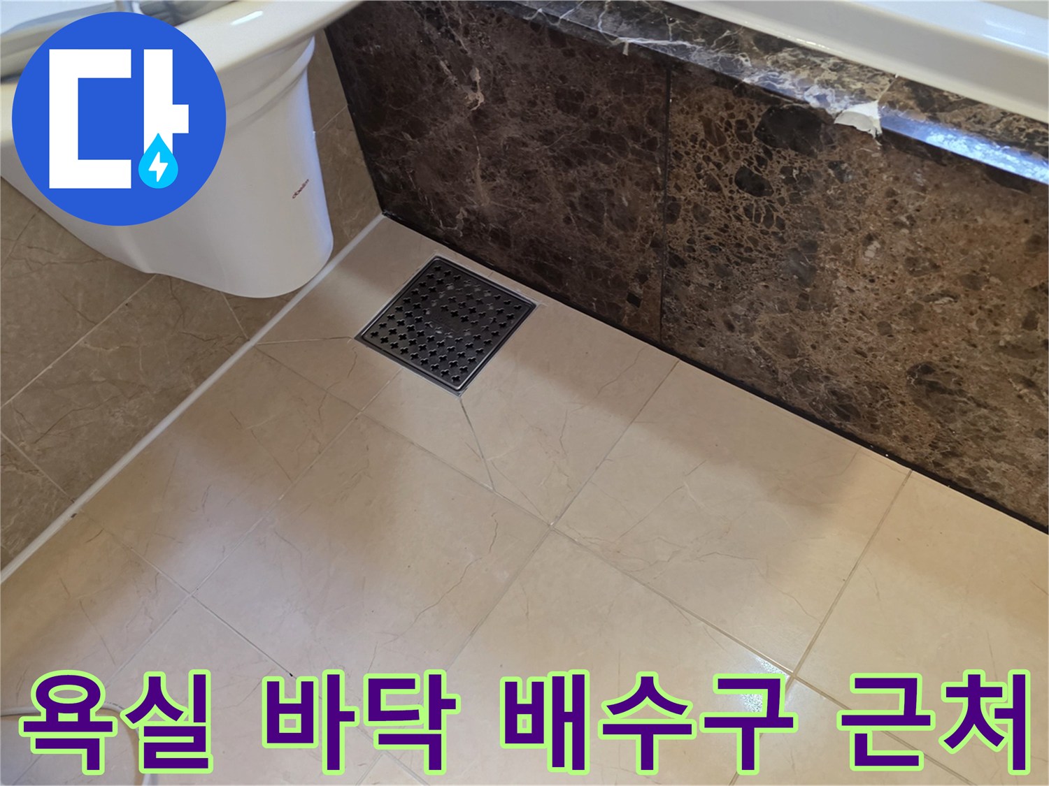 밝은 베이지색 타일과 어두운 색상의 욕조 측면 벽체