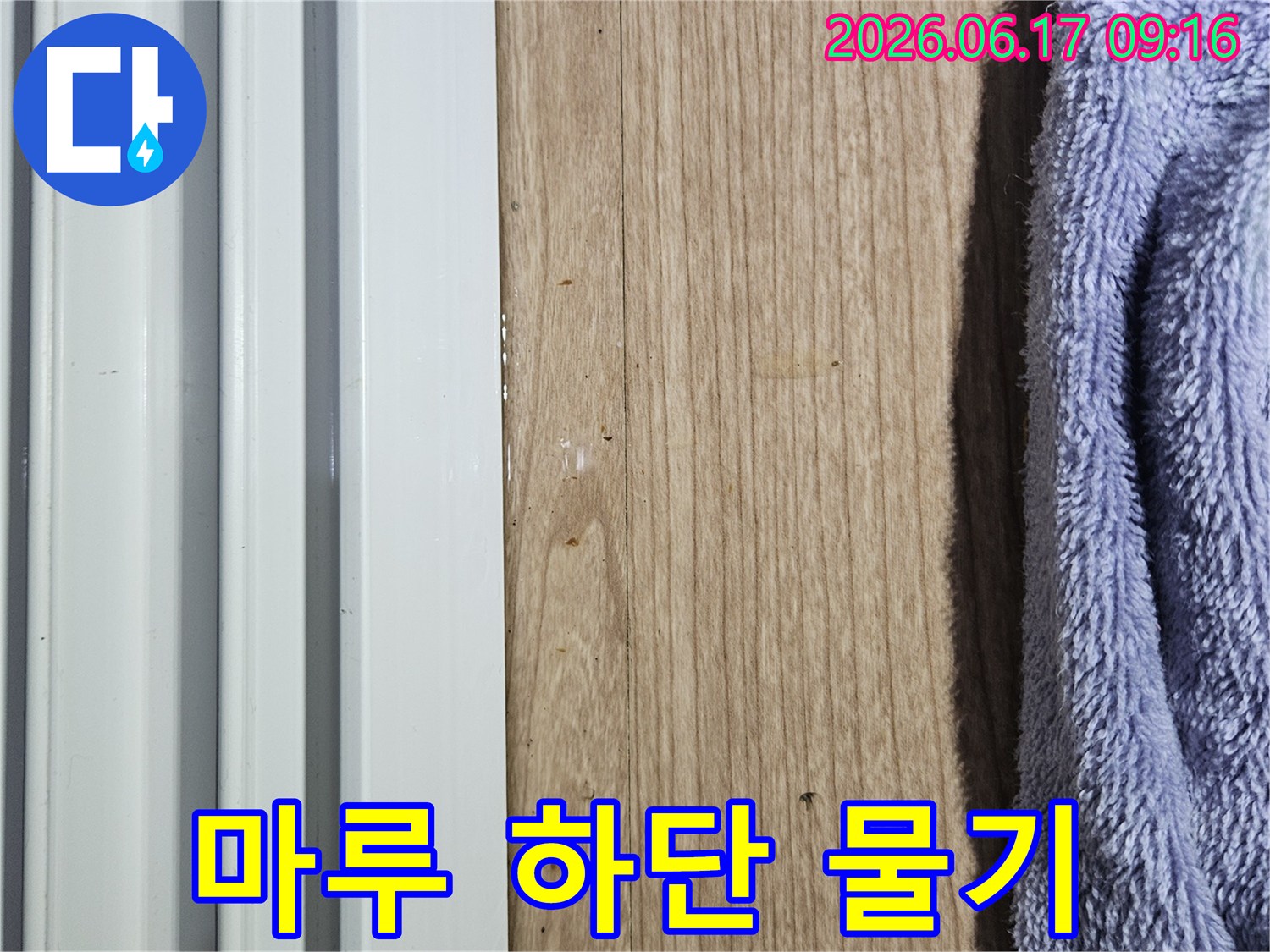 마루 하단부에 물기가 스며들어 젖어 있는 상태를 보여주는 누수 현장 사진