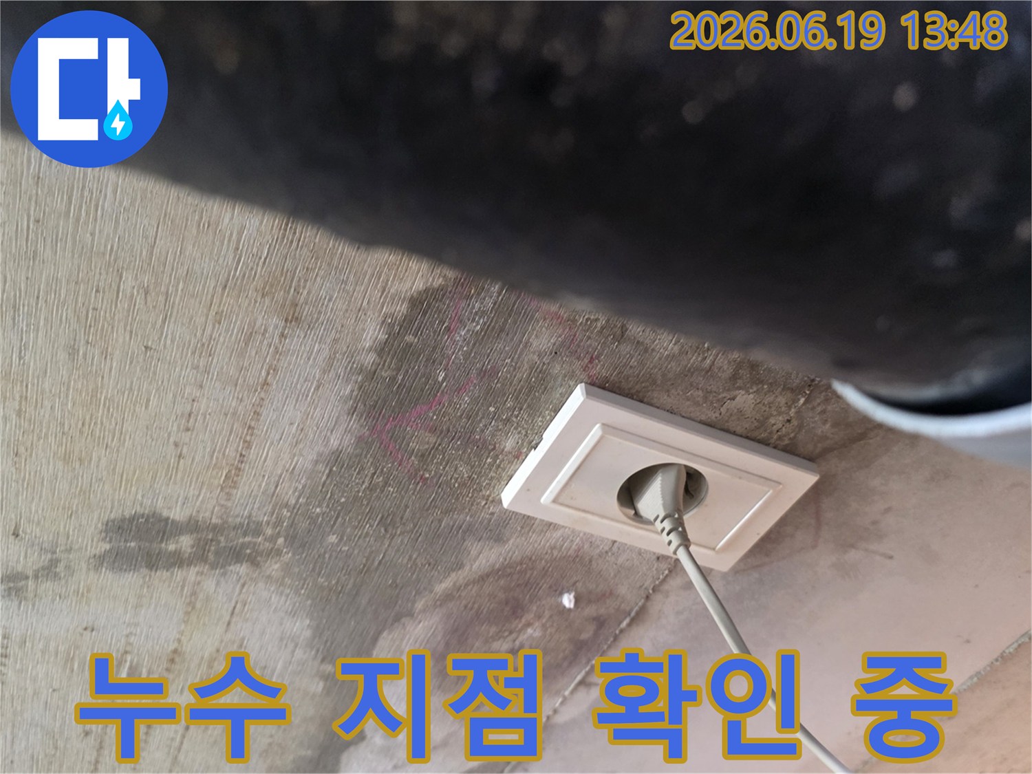 천장에 물이 새어 얼룩진 부분과-콘센트 주변의 물자국을 통해-누수 지점을 파악하는 현장 모습입니다