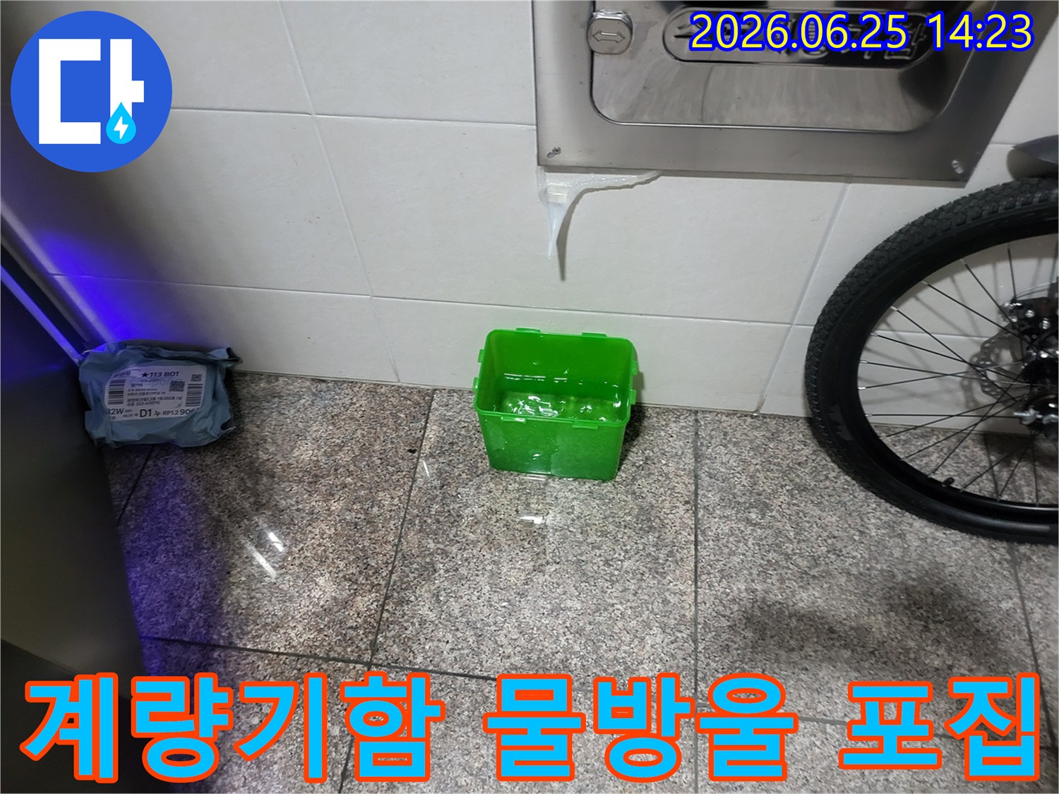 수도계량기함-아래에서-물이-새어-나와-초록색-물받이에-고이는-상황을-보여주는-누수-현장-사진
