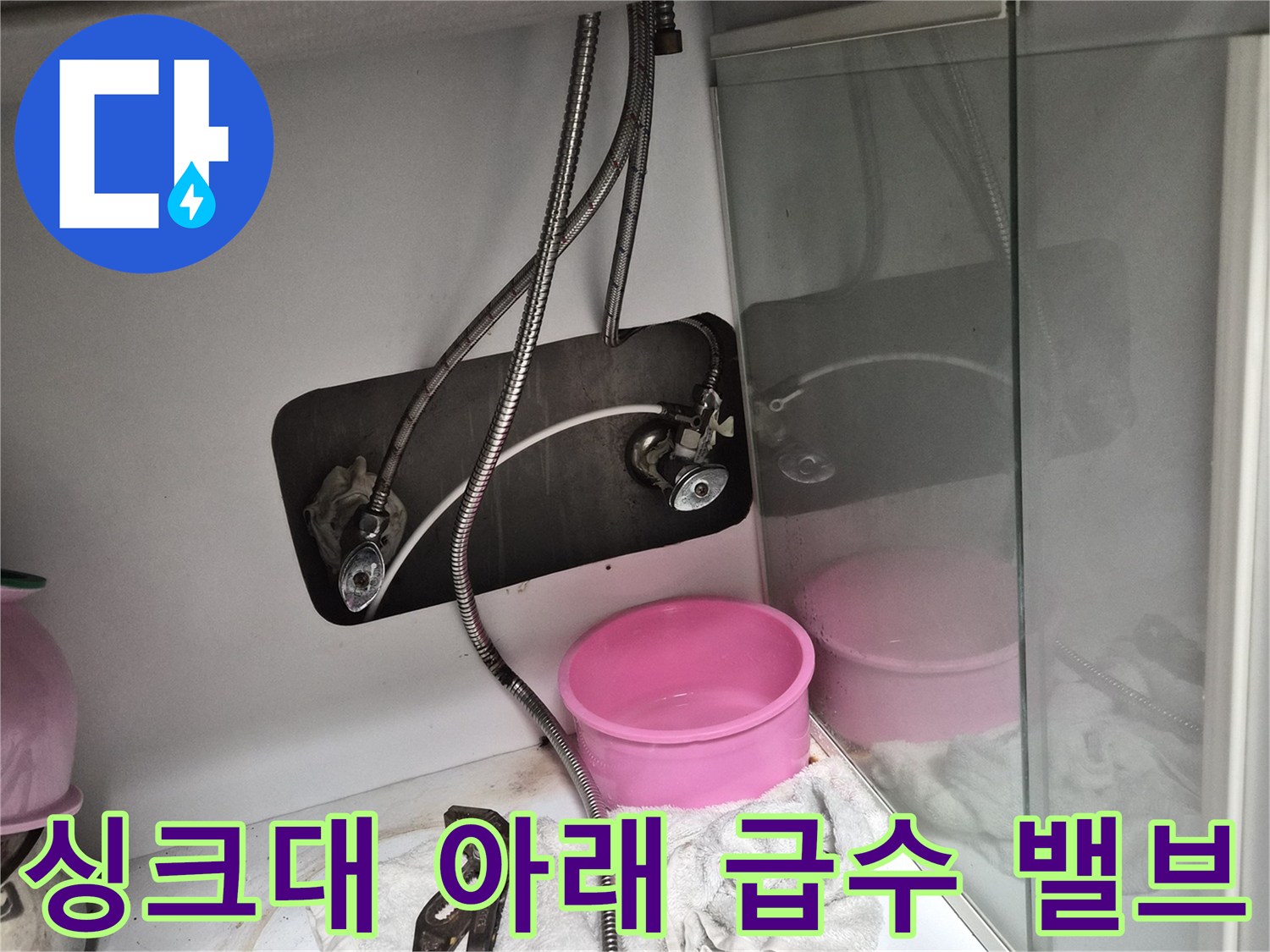 싱크대 하부의 금속 호스와 조절 밸브 상세 모습