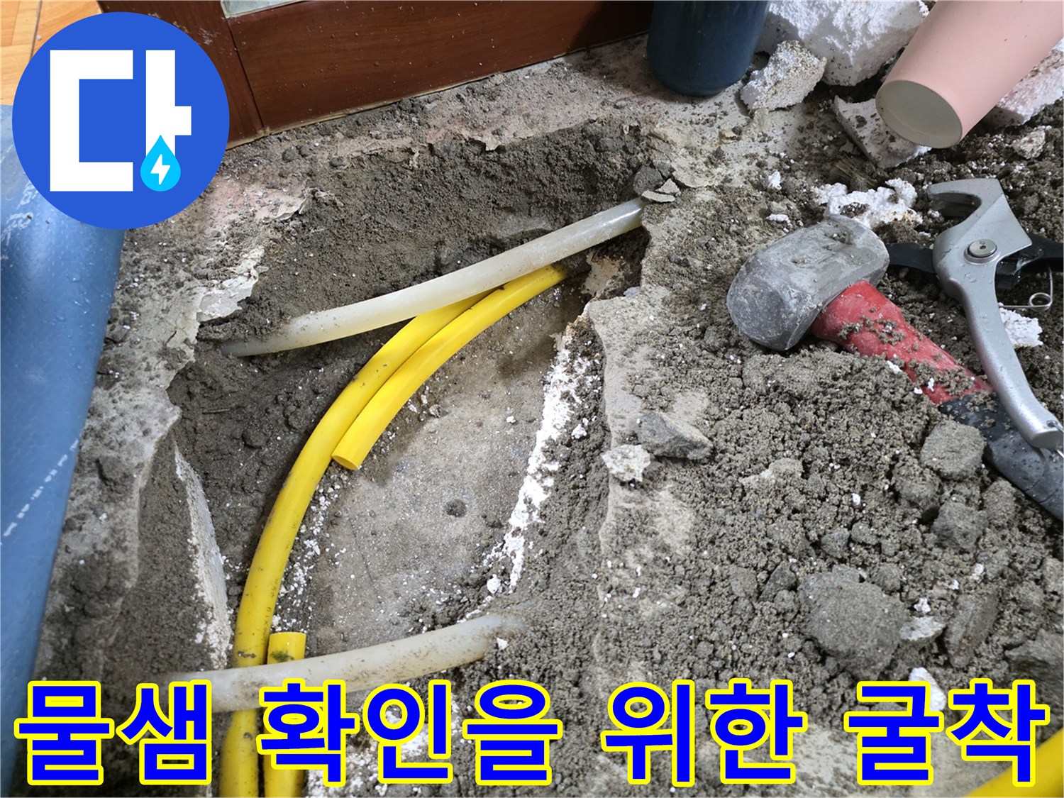 흙 속에 노출된 노란색 급수 배관과 공구들