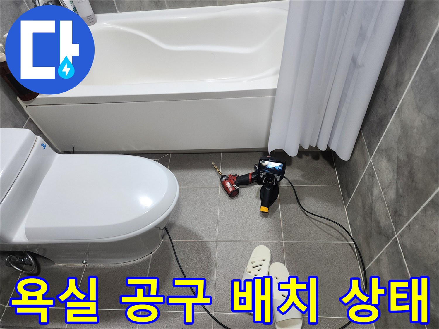 욕실 바닥의 전동 드릴과 작업용 슬리퍼