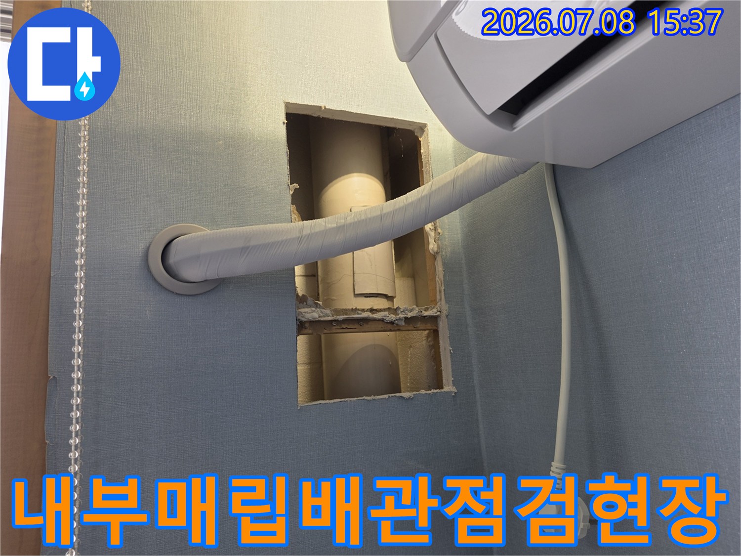 벽면 절개 부위를 통해 확인한 에어컨 배수 호스라인의 상세 모습