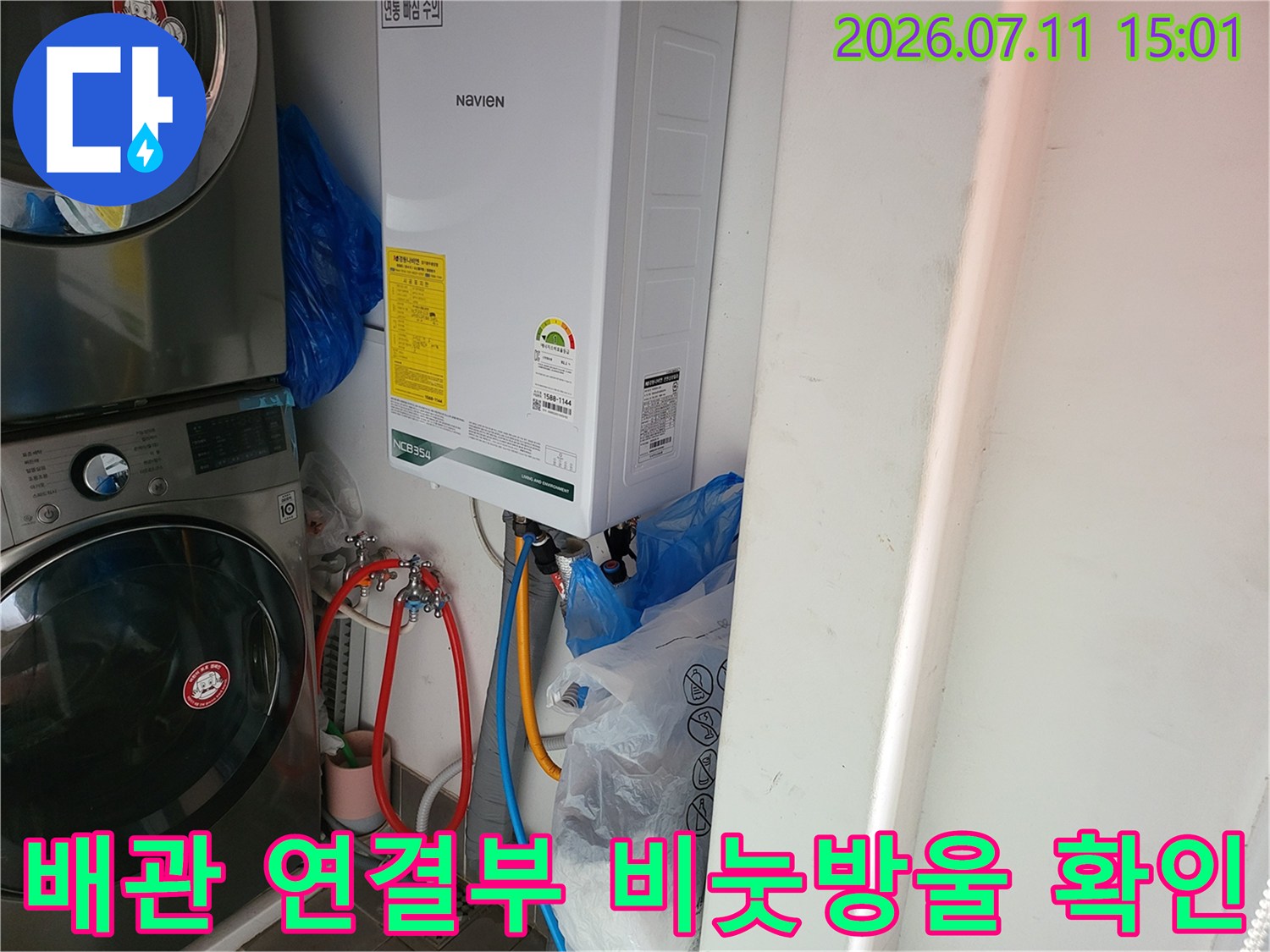온수기 주변 배관에 비눗물을 뿌려 누수 지점을 찾는 모습