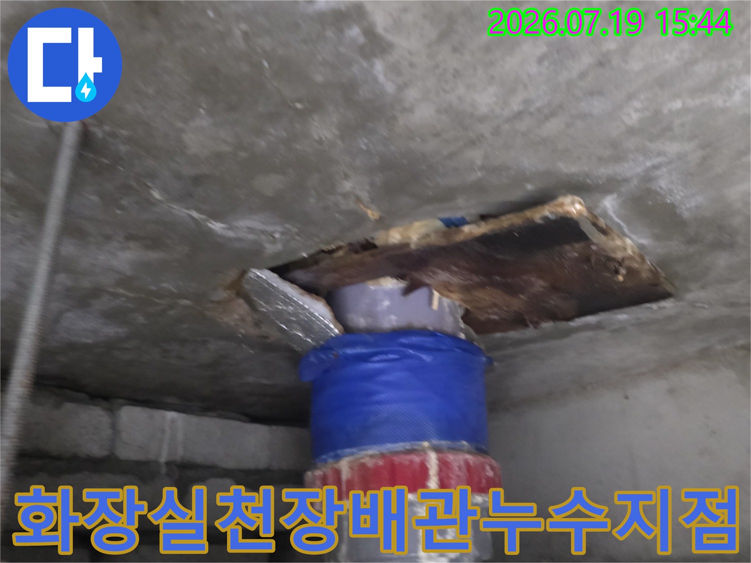 콘크리트-슬래브-천장에서-파란색-보온재로-감싸진-배관이-노출된-모습