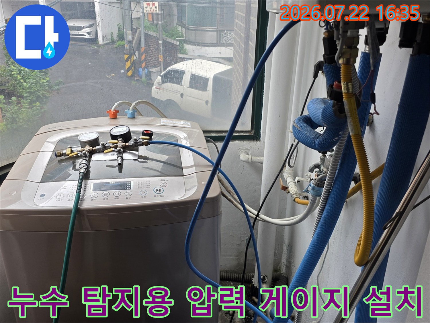 세탁실 내부에 배치된 누수 탐지 장비-파란색 호스가 배관과 연결되어 압력을 측정하는 사진