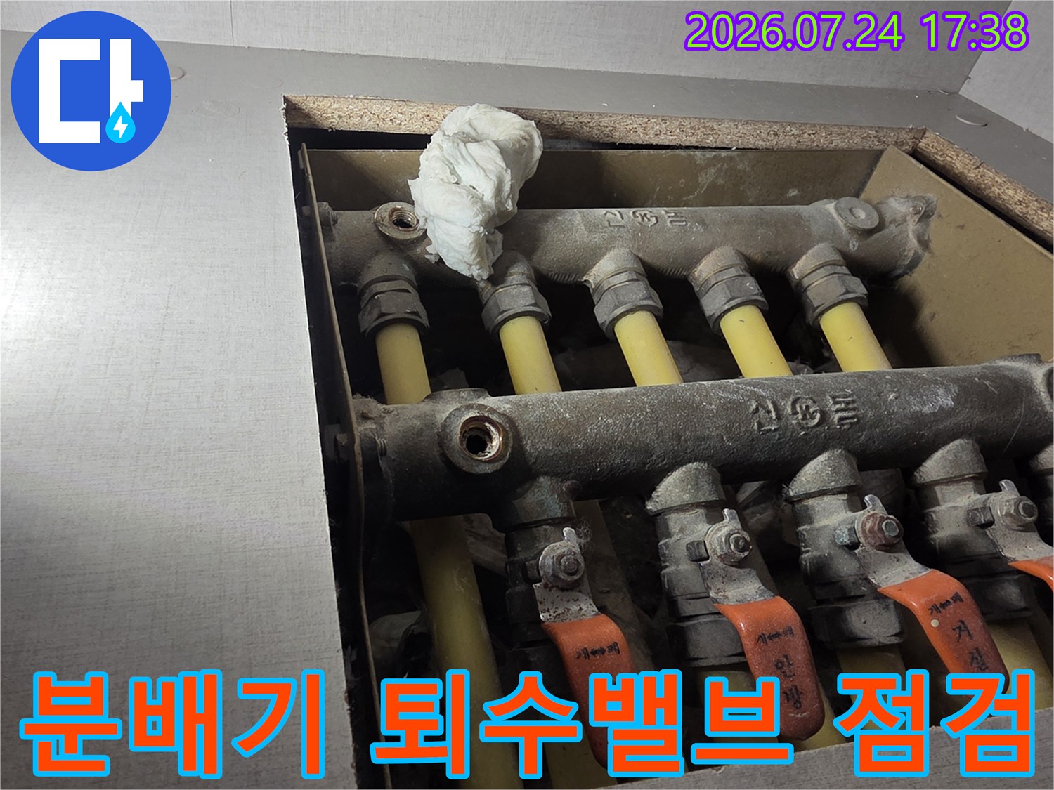 노후된 분배기 배관과 오렌지색 퇴수밸브를 점검하는 모습