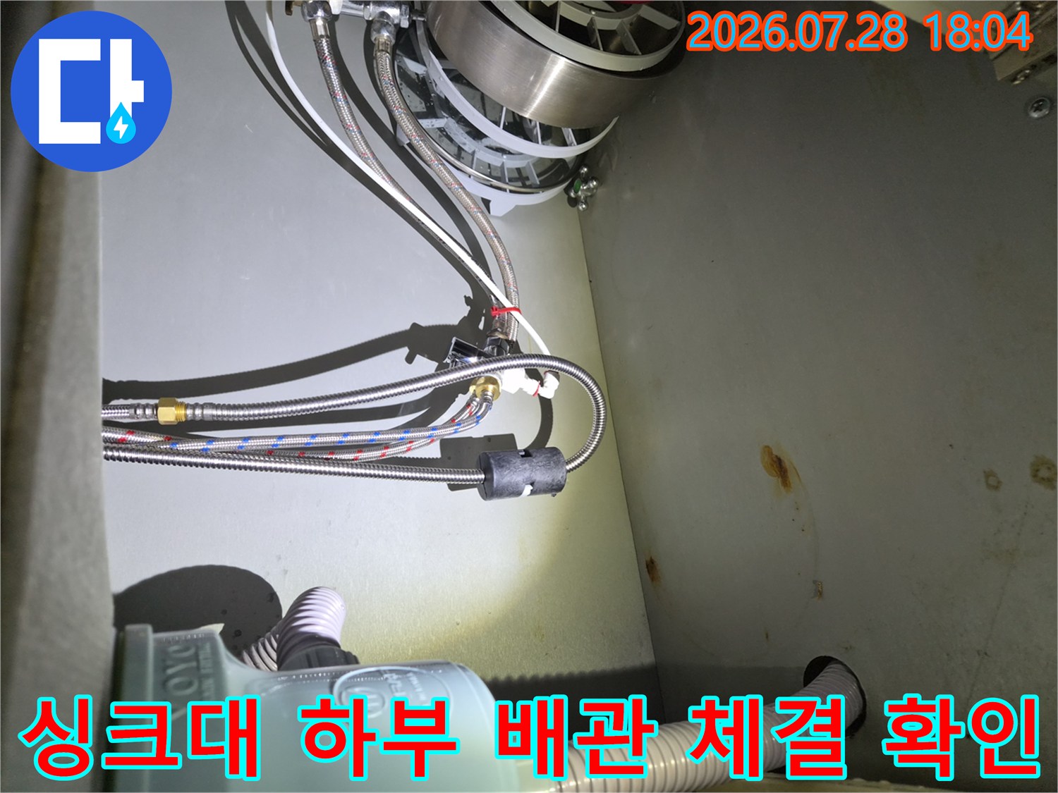 식기세척기와 연결된 여러 갈래의 수도 호스 및 분기배관 부위의 누수 여부를 점검하는 과정