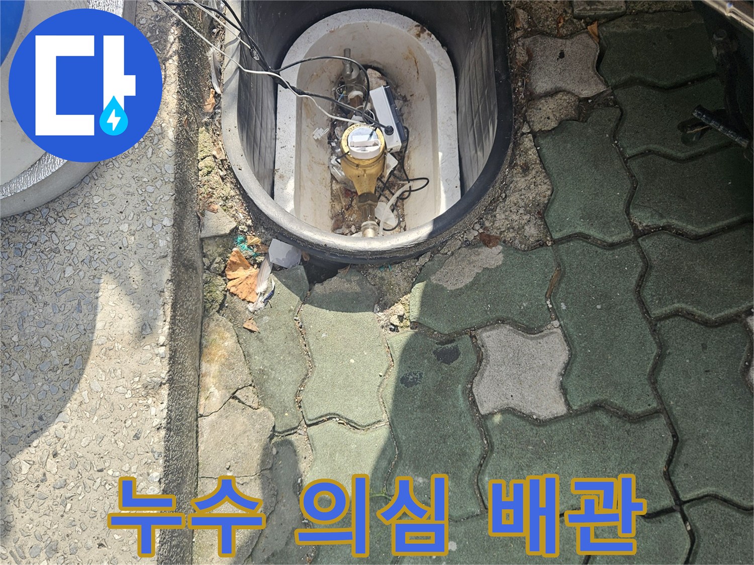 보도블록 사이로 노출된 녹슬고 오염된 배관 연결 부위 상세
