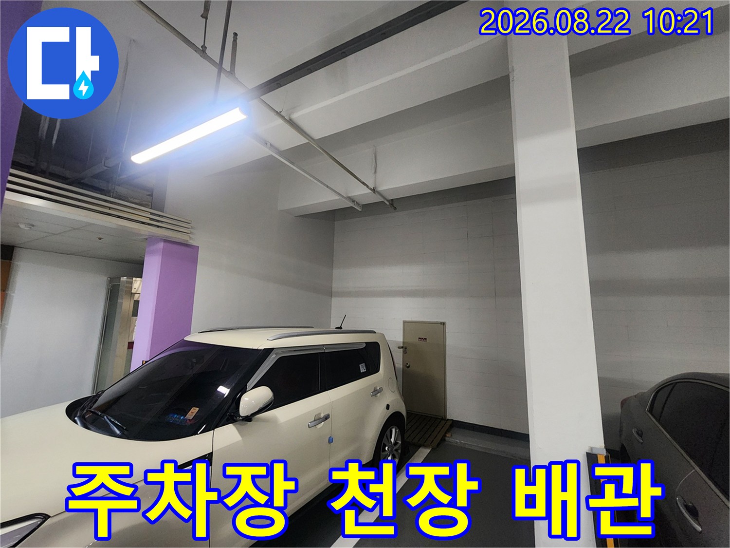 지하-주차장-천장에-설치된-배관과-조명-시설