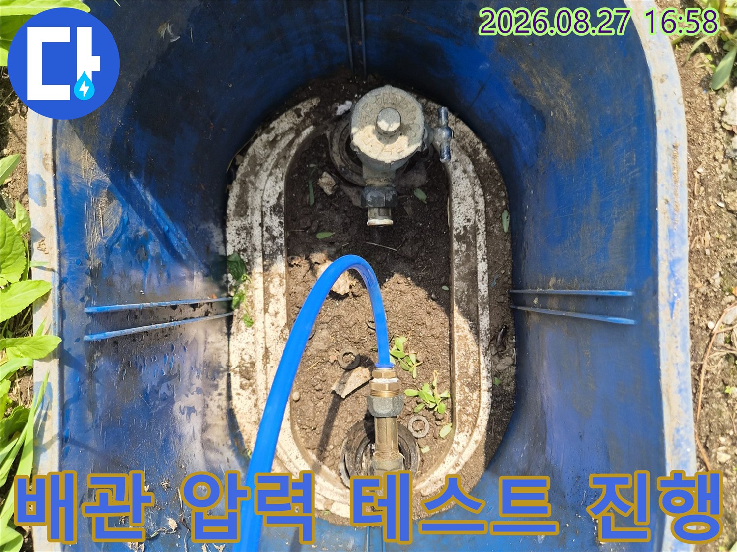 파란색 호스가 배관 부속에 연결되어 압력을 측정합니다.