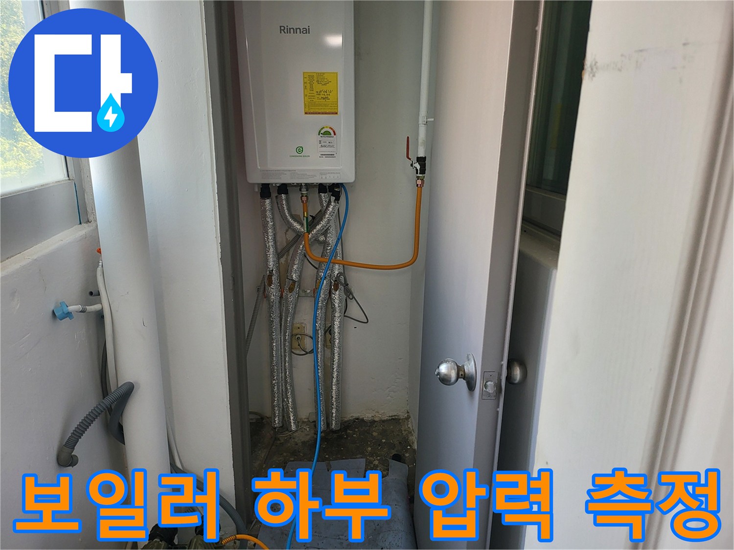 보일러 아래 연결된 배관들과 압력계 모습