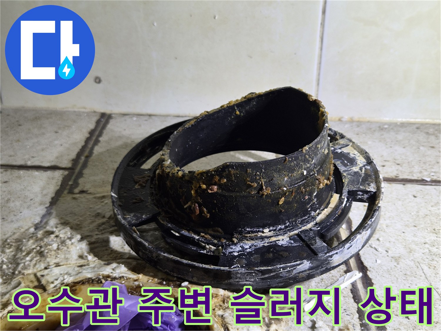 양변기 탈거 후 드러난 오수관 주변의 이물질과 슬러지 상태