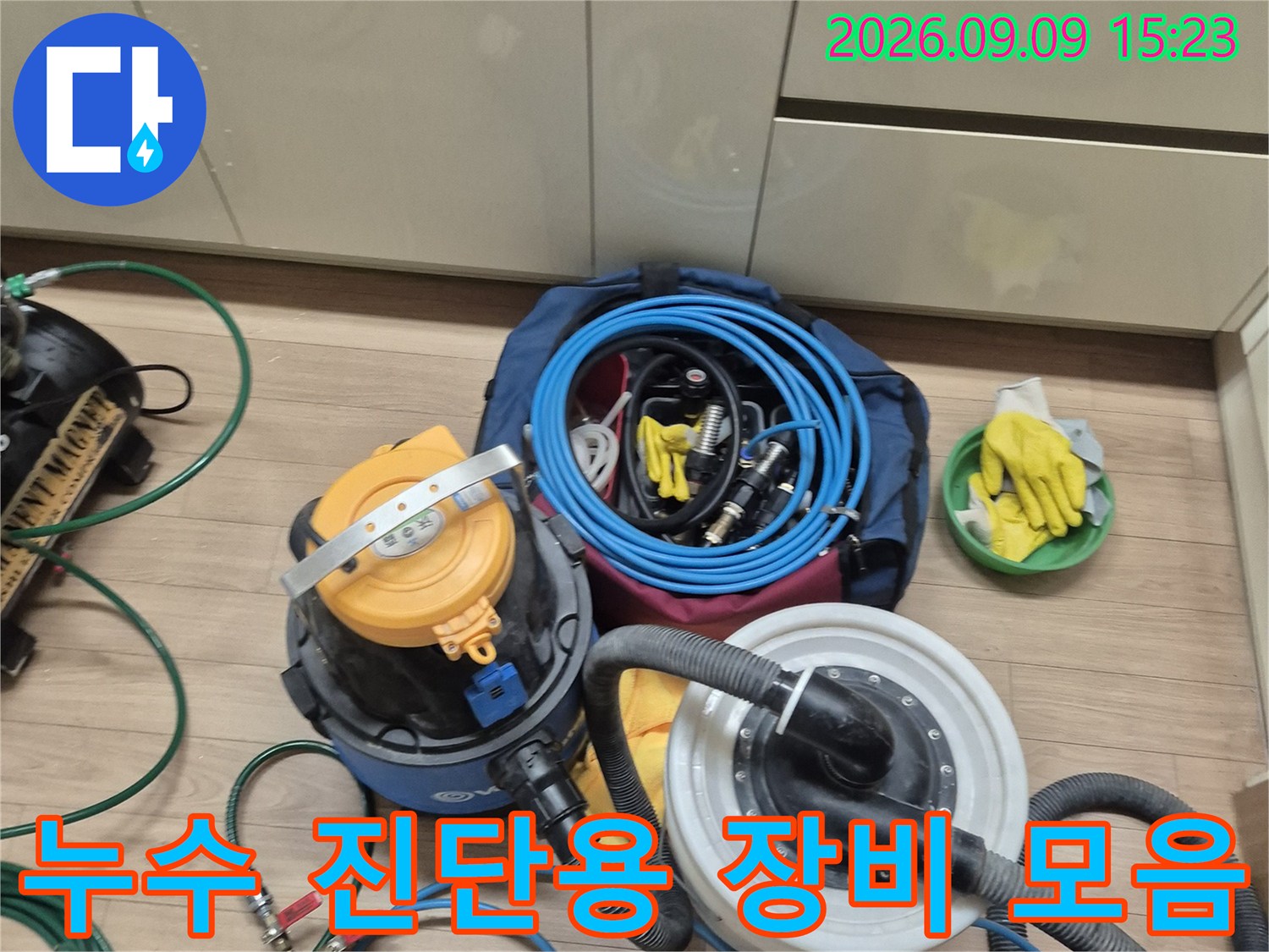 누수 탐지를 위해 현장에 준비된 압력 게이지와 노란색 릴 호스 및 작업 도구