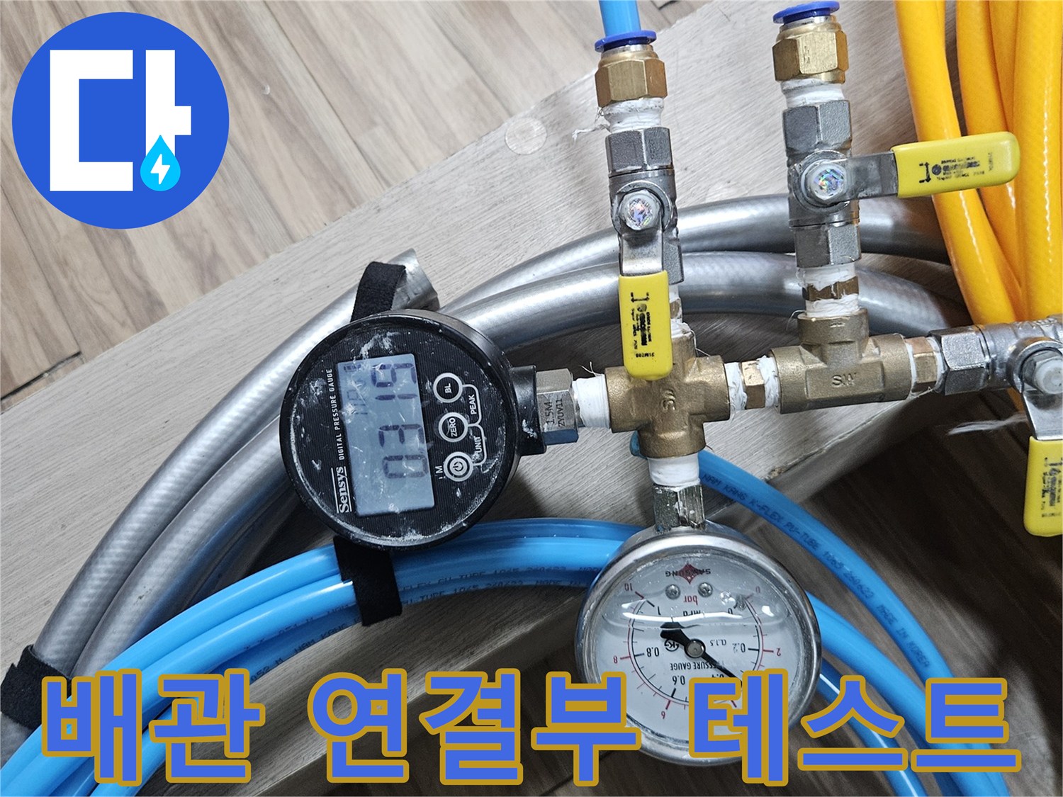 배관 분기점에 설치된 압력 측정 장비와 노란색 호스 연결 상태